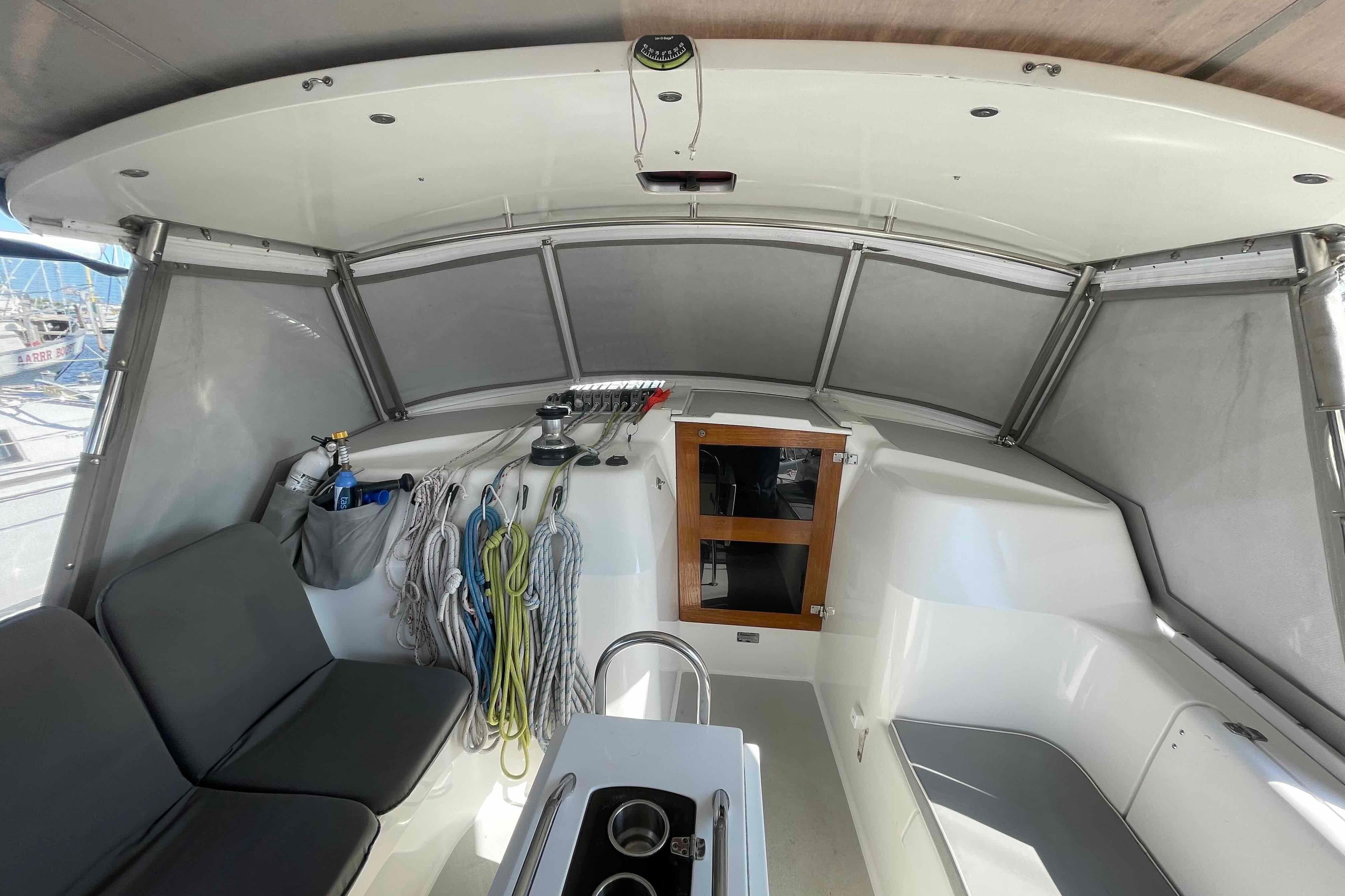 Interior view of 2013 Catalina Morgan 440 sailboat cockpit with seating and storage.