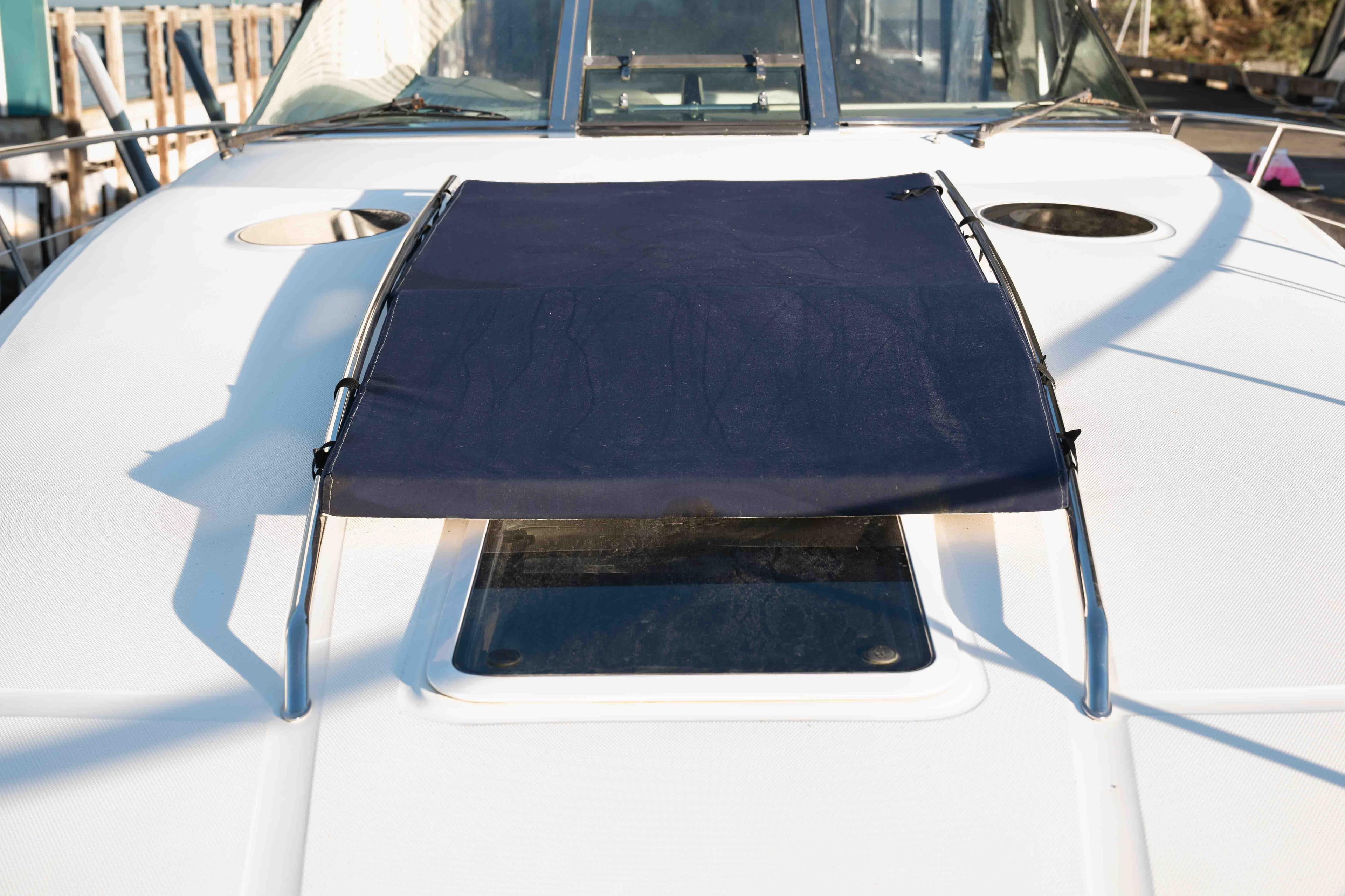 2004 Sea Ray 360 Sundancer boat deck with sunshade and hatch.