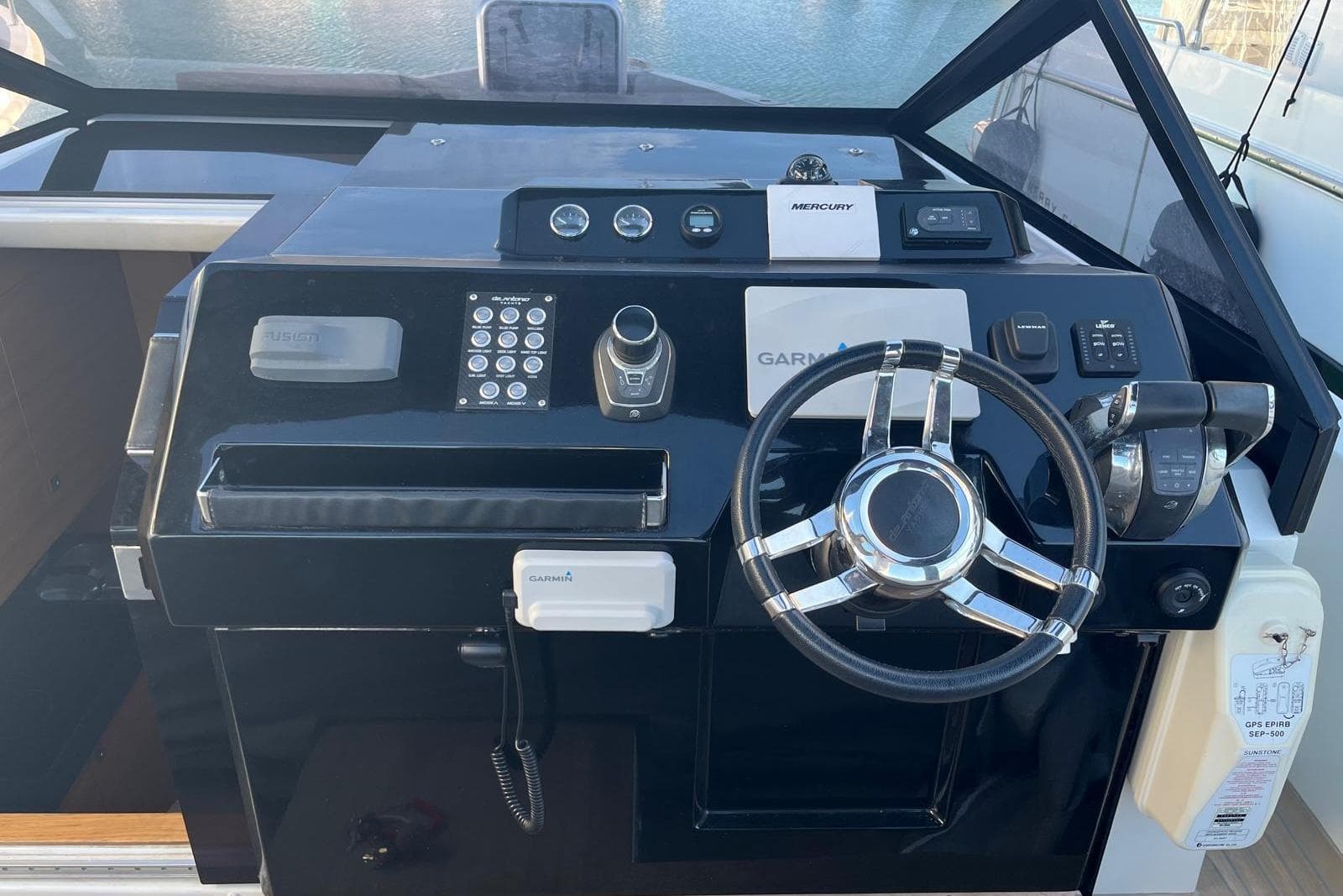 Control panel of a 2018 De Antonio Yachts D33, featuring steering wheel and navigation instruments.