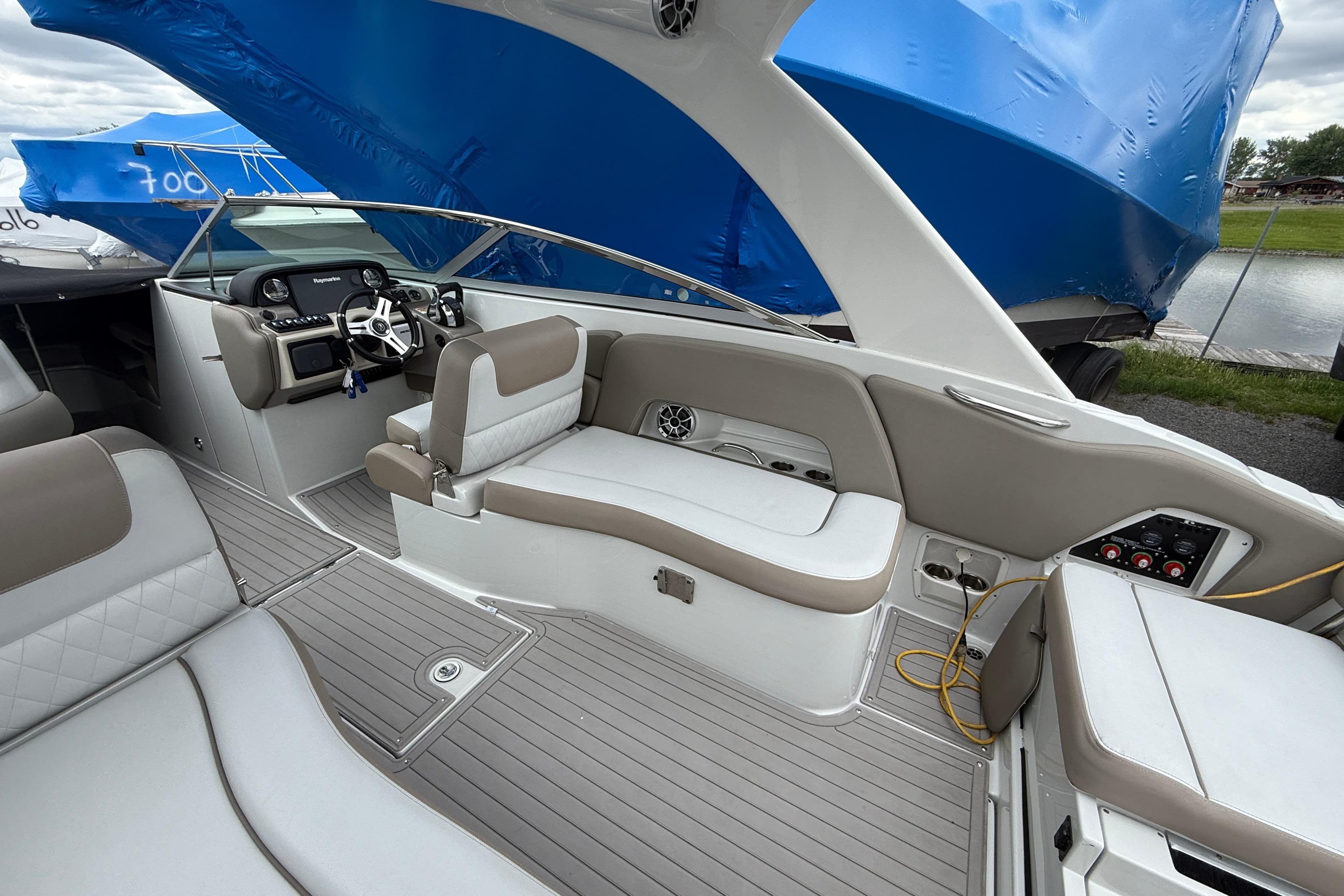 2018 Crownline Eclipse E30 boat interior with beige seating and modern dashboard.