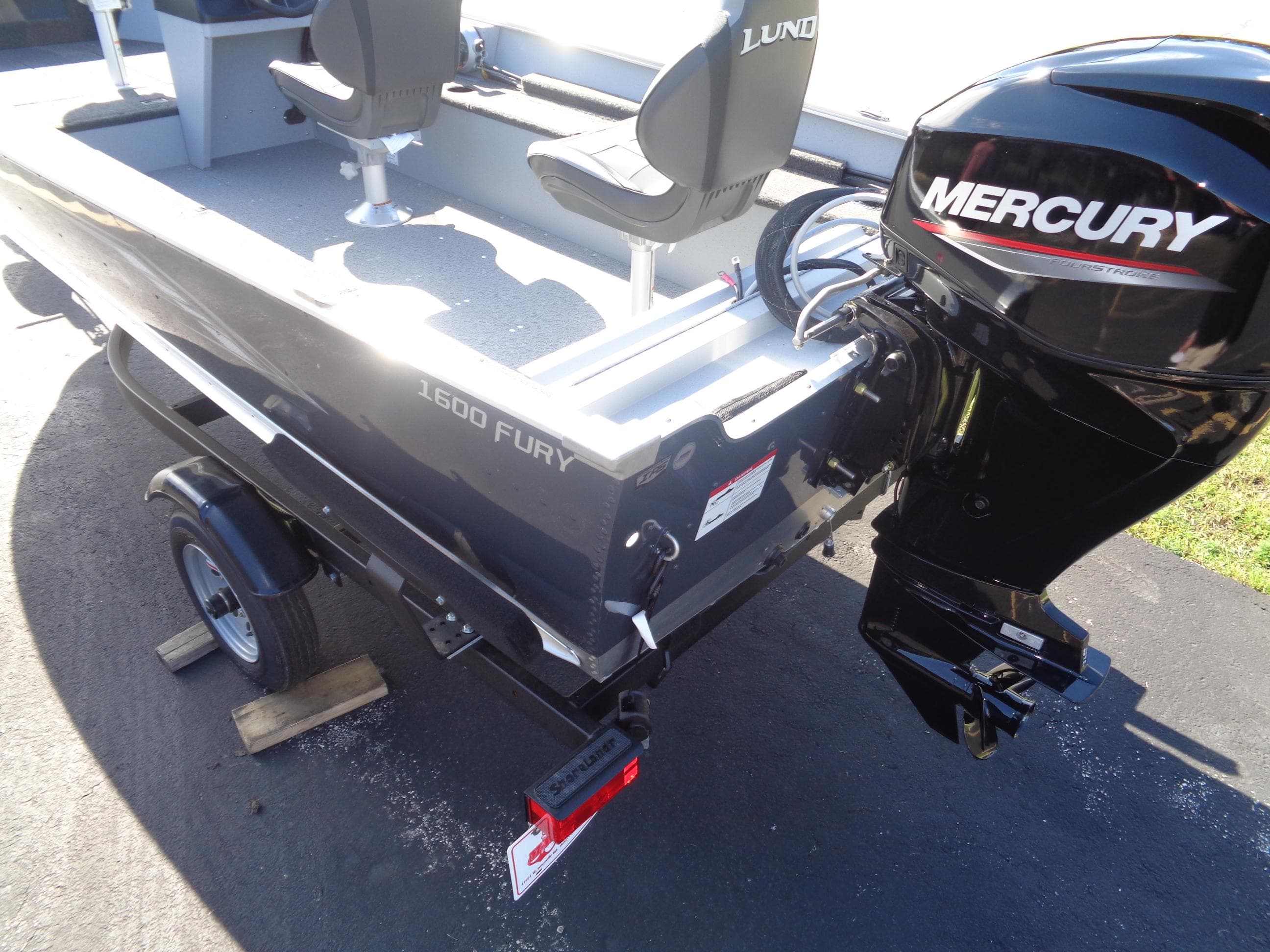 2025 Lund 1600 Fury SS boat with Mercury outboard motor on trailer.