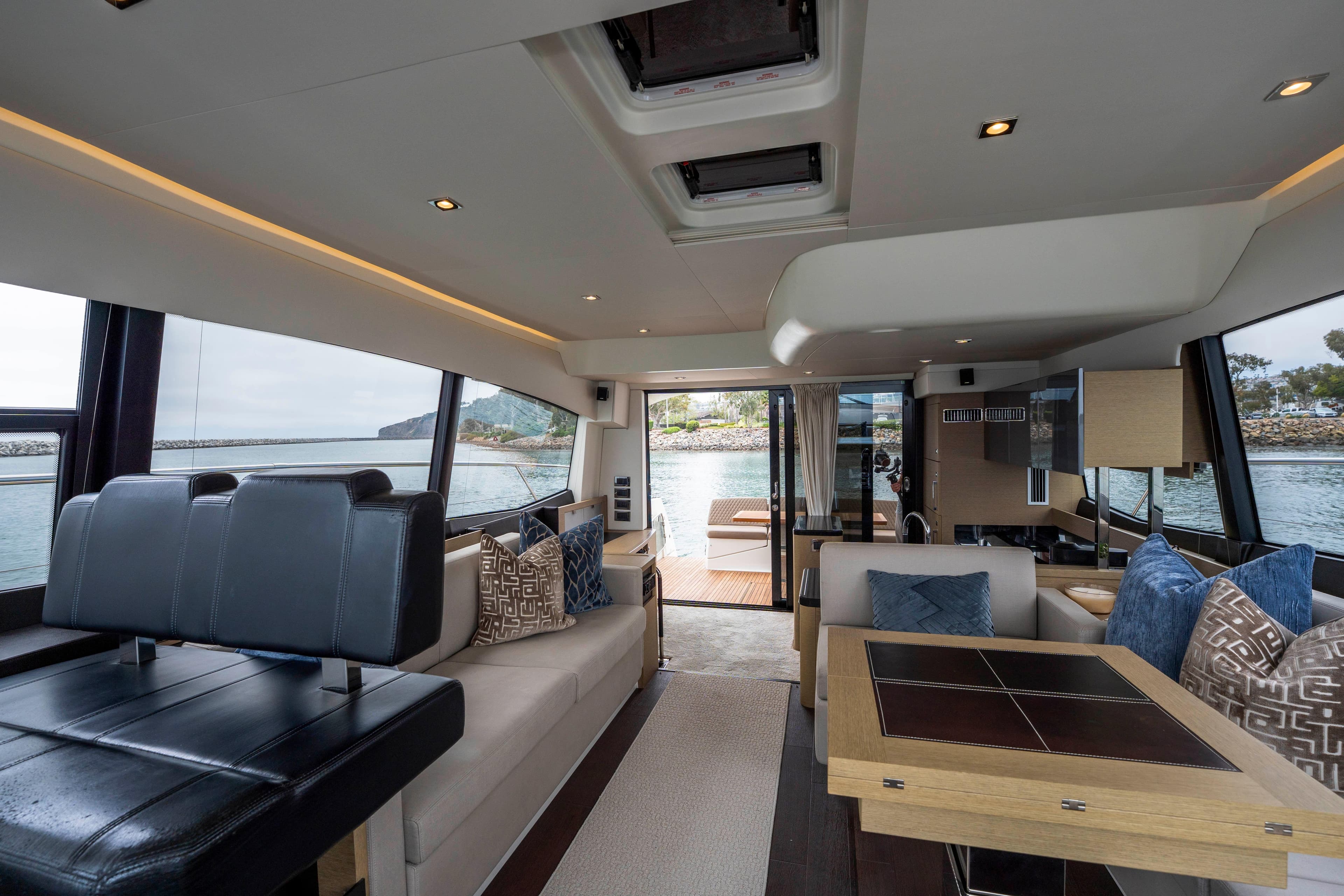 Luxurious interior of 2018 Prestige 560 yacht with elegant seating and scenic views.