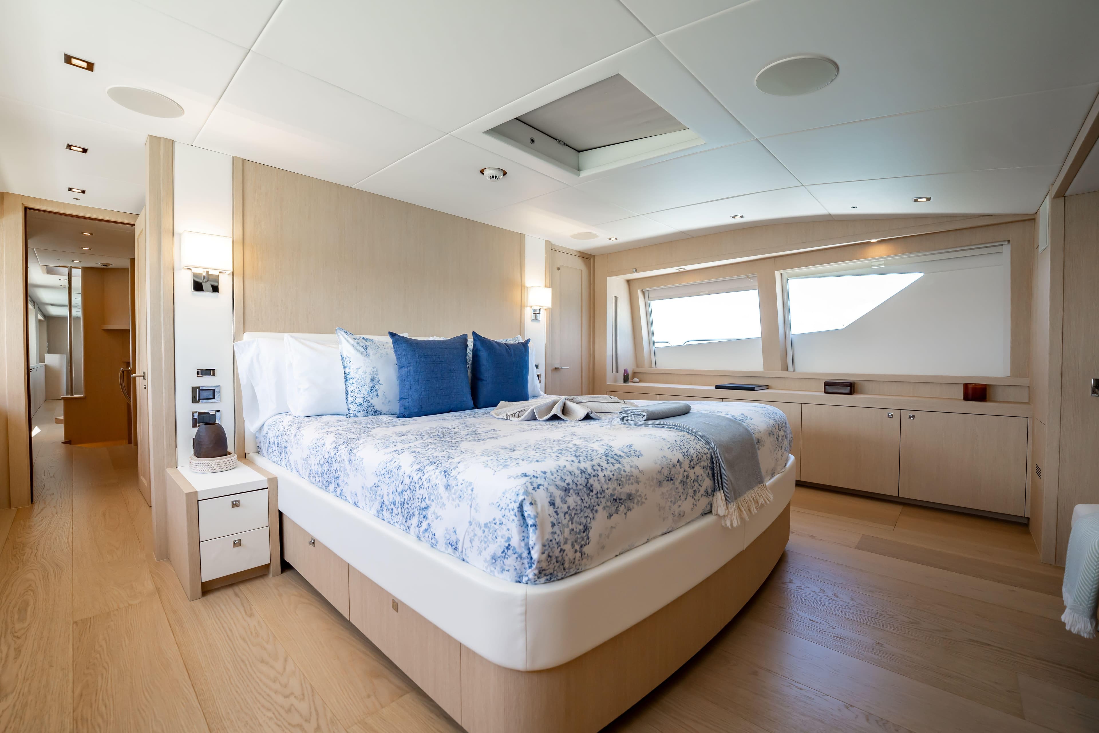 Luxurious bedroom interior on a 2011 Sunseeker 34 Metre Yacht, featuring elegant decor and large windows.