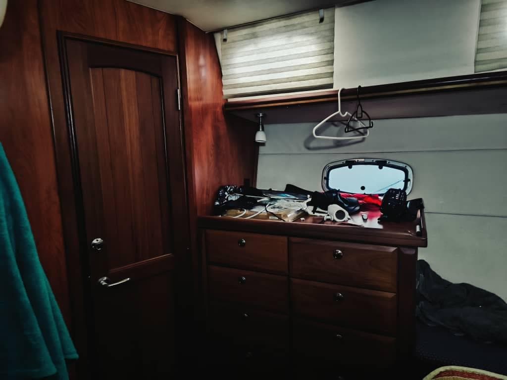 Interior of 2010 Hunter 50 Center Cockpit with wooden cabinetry and porthole.