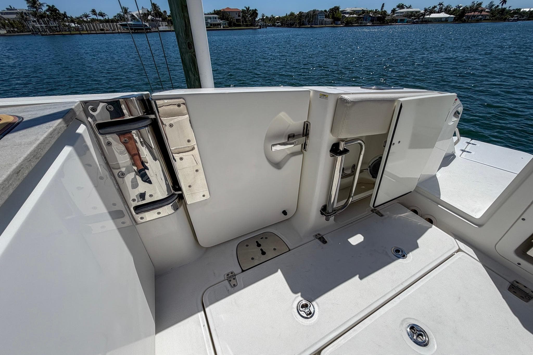 2017 Boston Whaler 320 Vantage boat deck with open door, overlooking water.