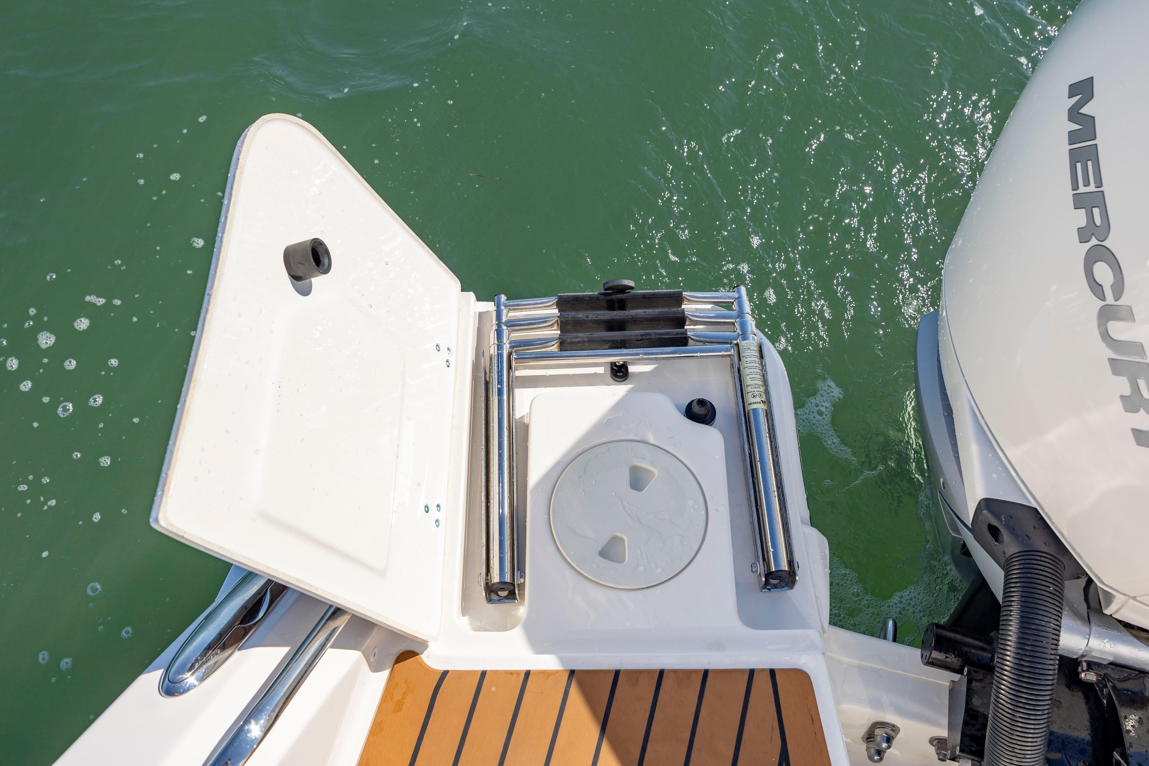 2023 Boston Whaler 320 Vantage swim platform with ladder and Mercury engine.