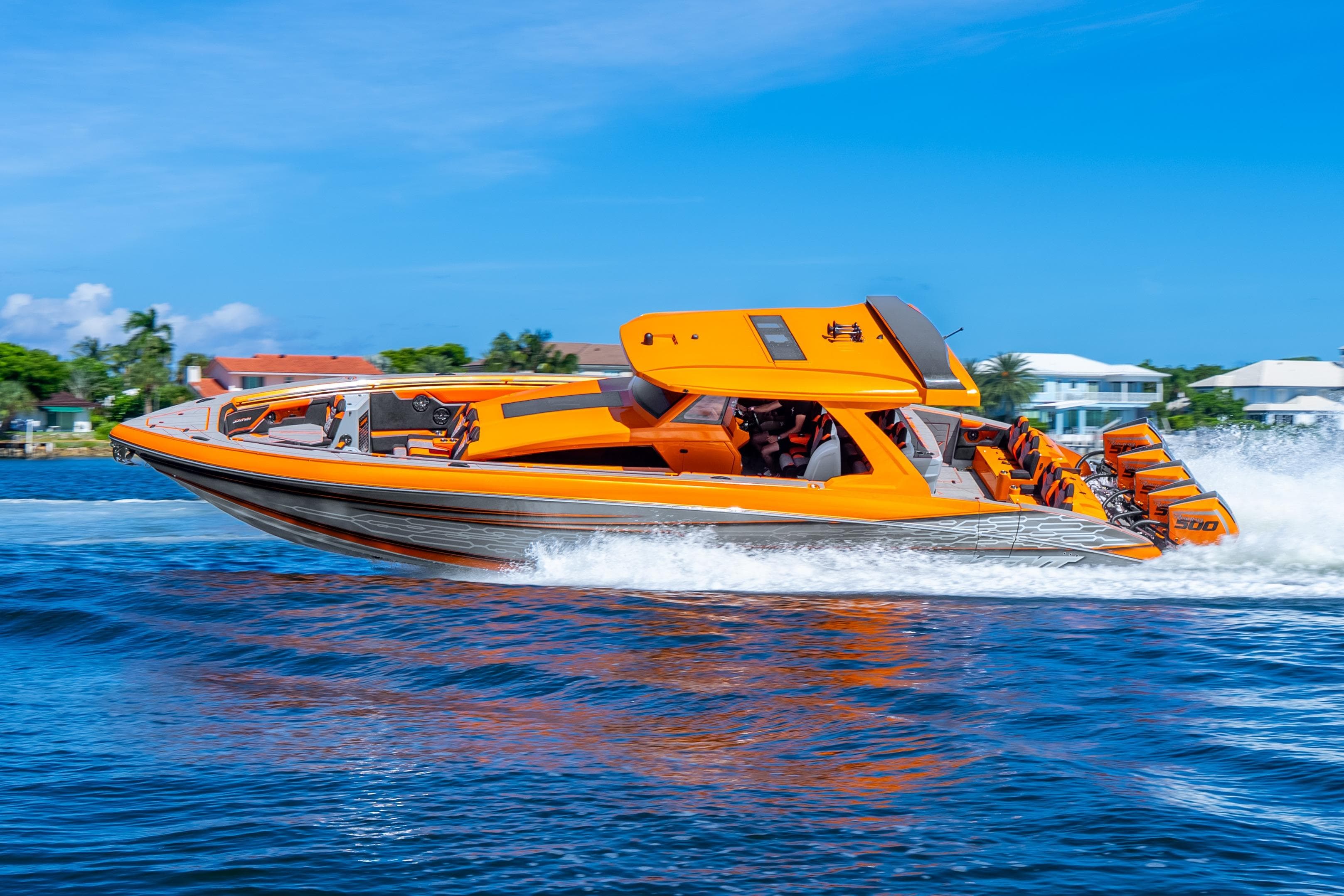 Orange 2025 Statement 44 GRTS speedboat cruising on blue water, showcasing sleek design and powerful engines.