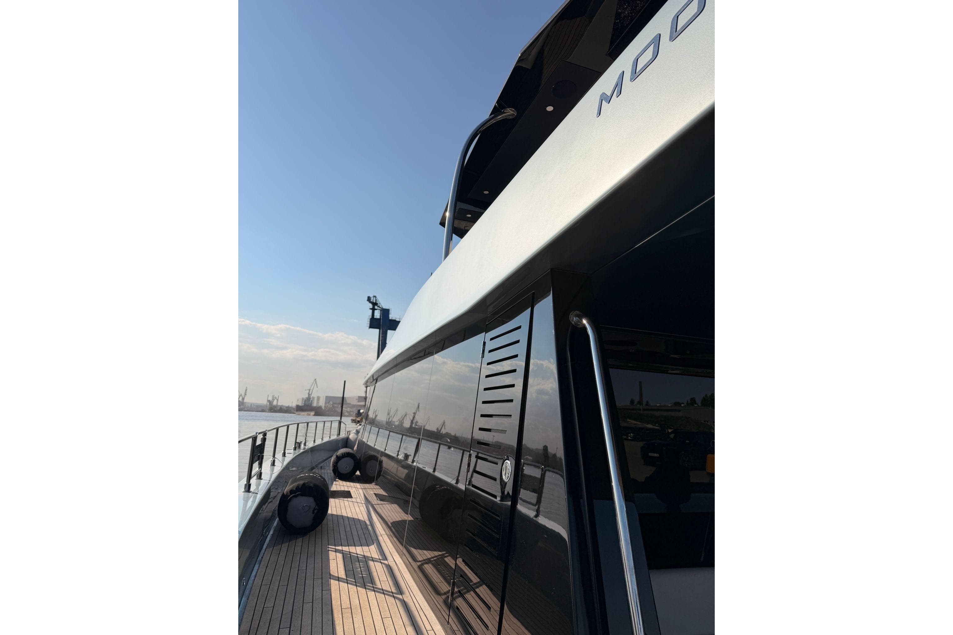 Luxurious 2026 Moon 60 Power yacht with sleek design and wooden deck.