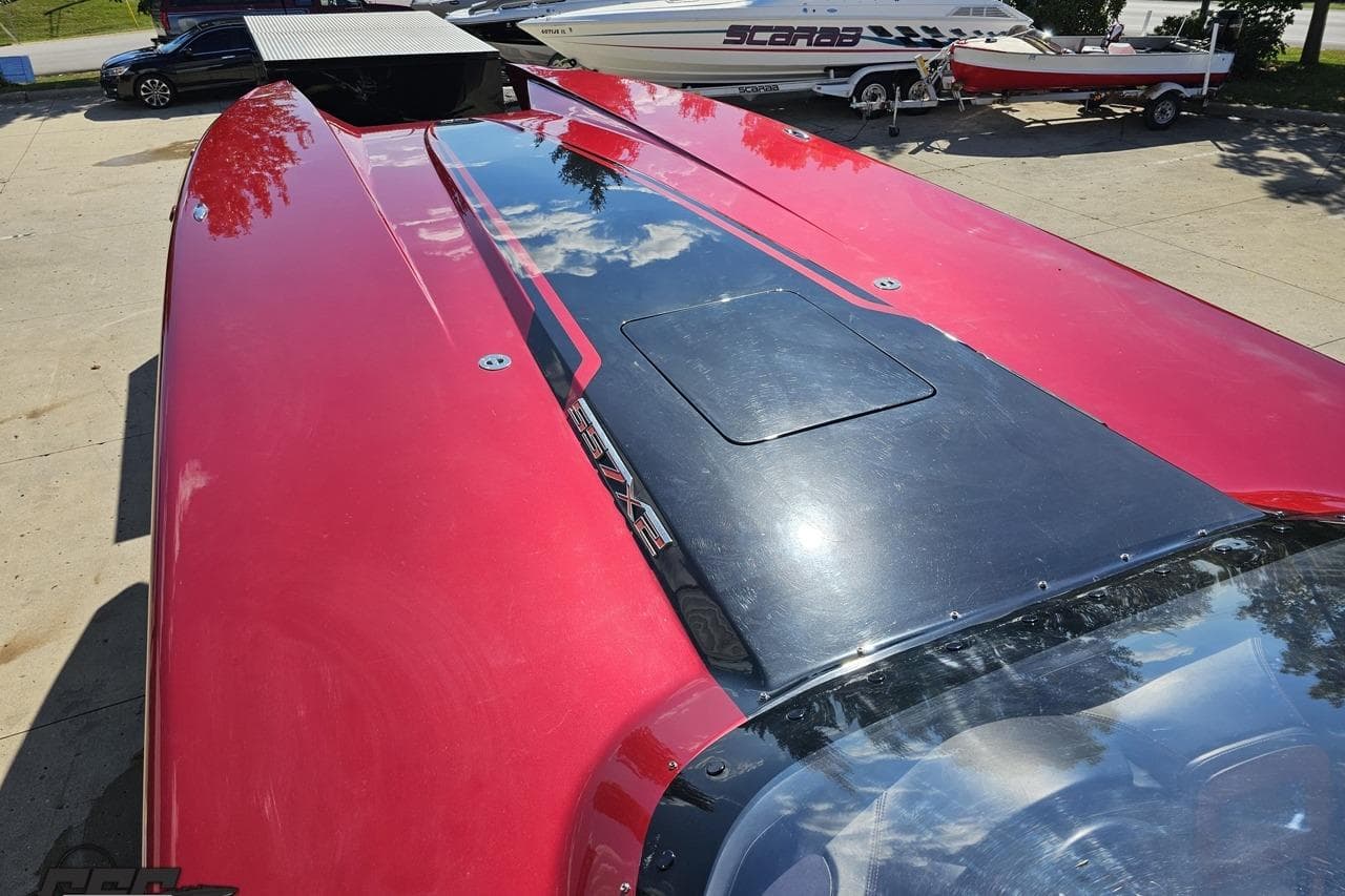 Red MTI 44 Corvette boat, 2010 model, with sleek design and reflective surface.