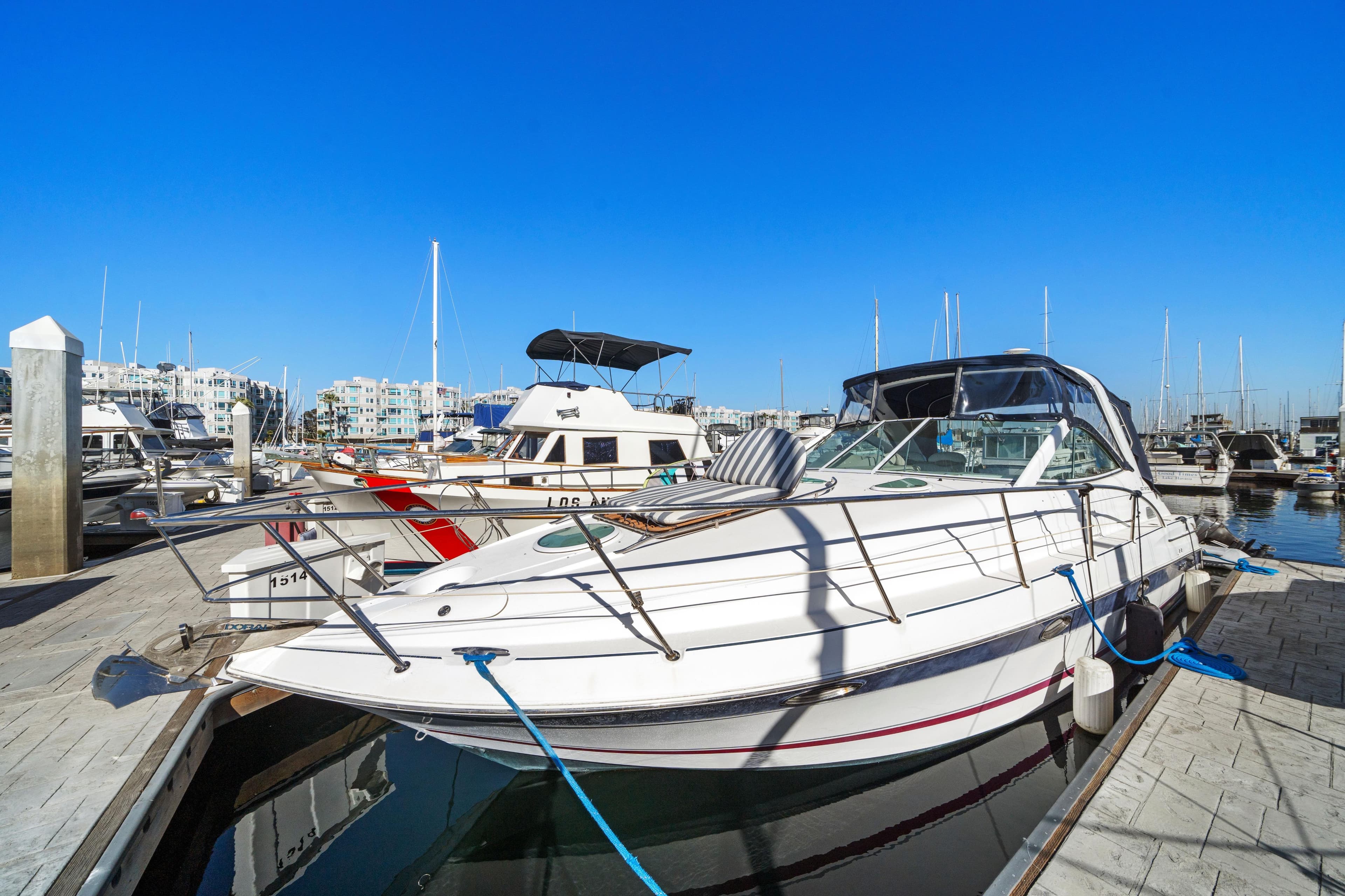 2005 Doral 360se yacht docked at marina under clear blue sky.