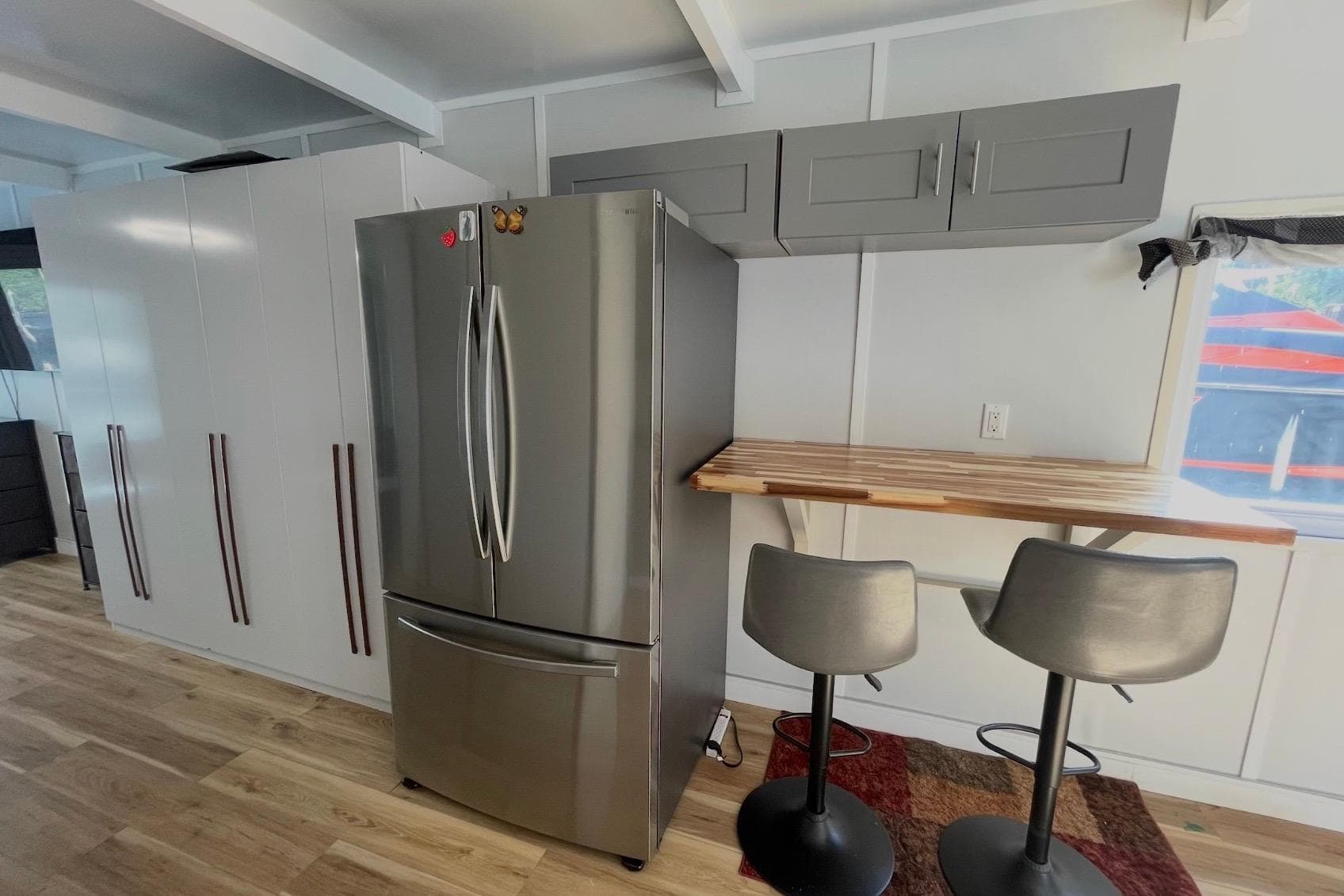 Modern kitchen with stainless steel fridge, sleek cabinets, and breakfast bar, 2023 Modern Struktures MS400.