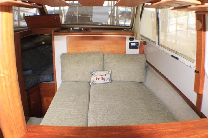 Interior of 1988 Tollycraft 30 Sport Cruiser with cozy seating and nautical decor.