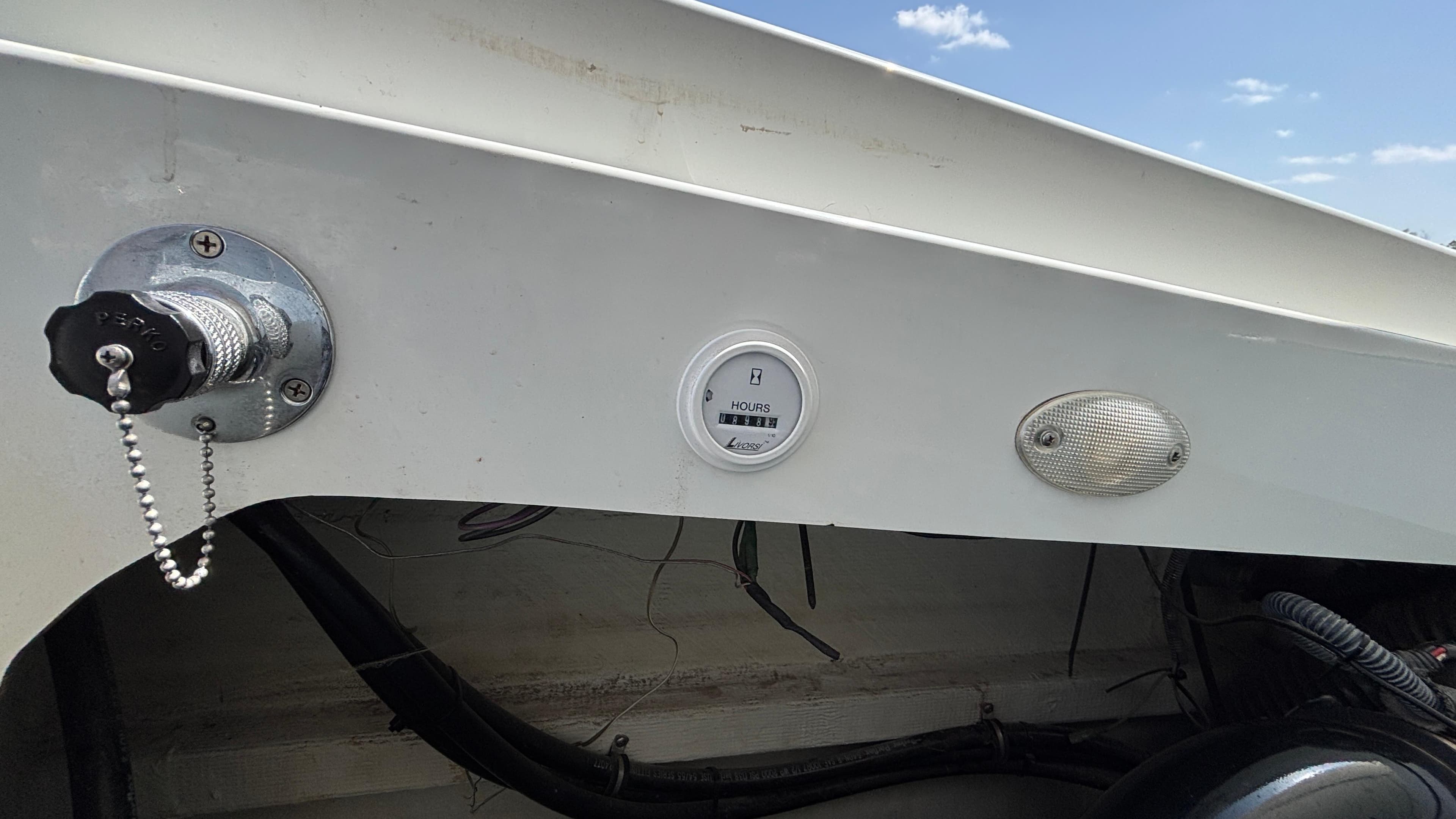 2005 Baja 33 Outlaw boat dashboard with hour meter and fuel cap.