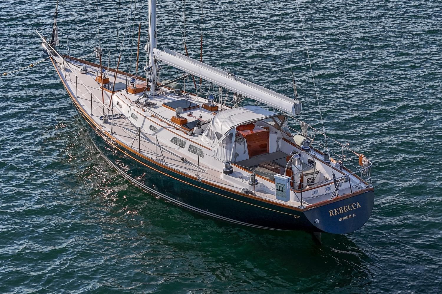 1989 Hinckley Sou'wester 51 sailboat on water, named "Rebecca," with elegant design.