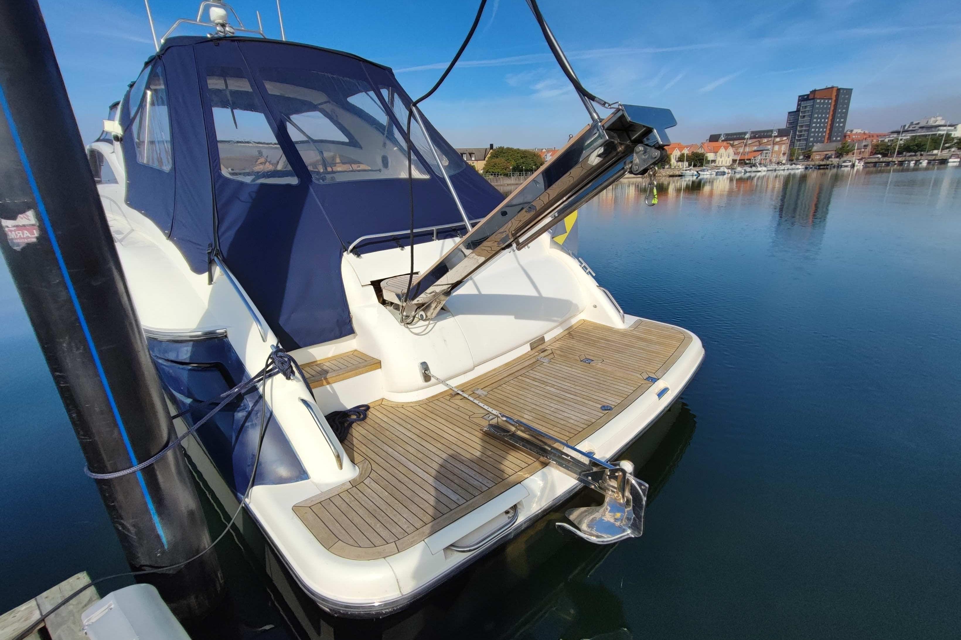 1998 Princess V55 yacht docked, featuring a sleek design and spacious deck.