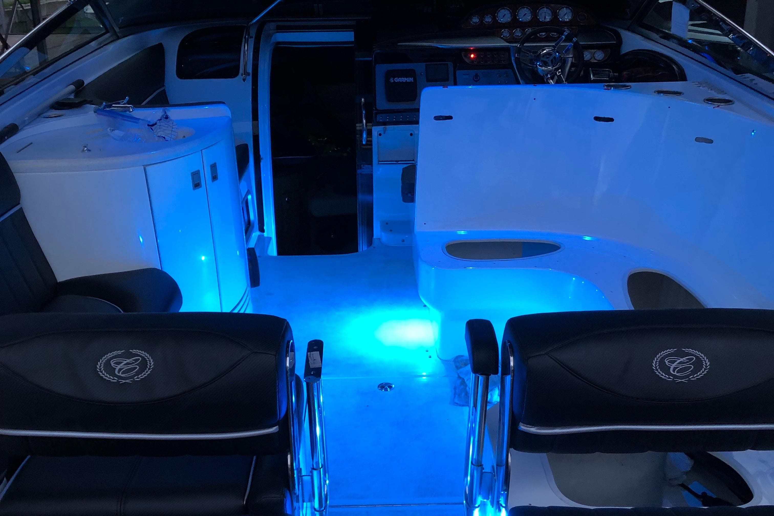 Interior of 2005 Cobalt 360 boat with blue ambient lighting and sleek seating.