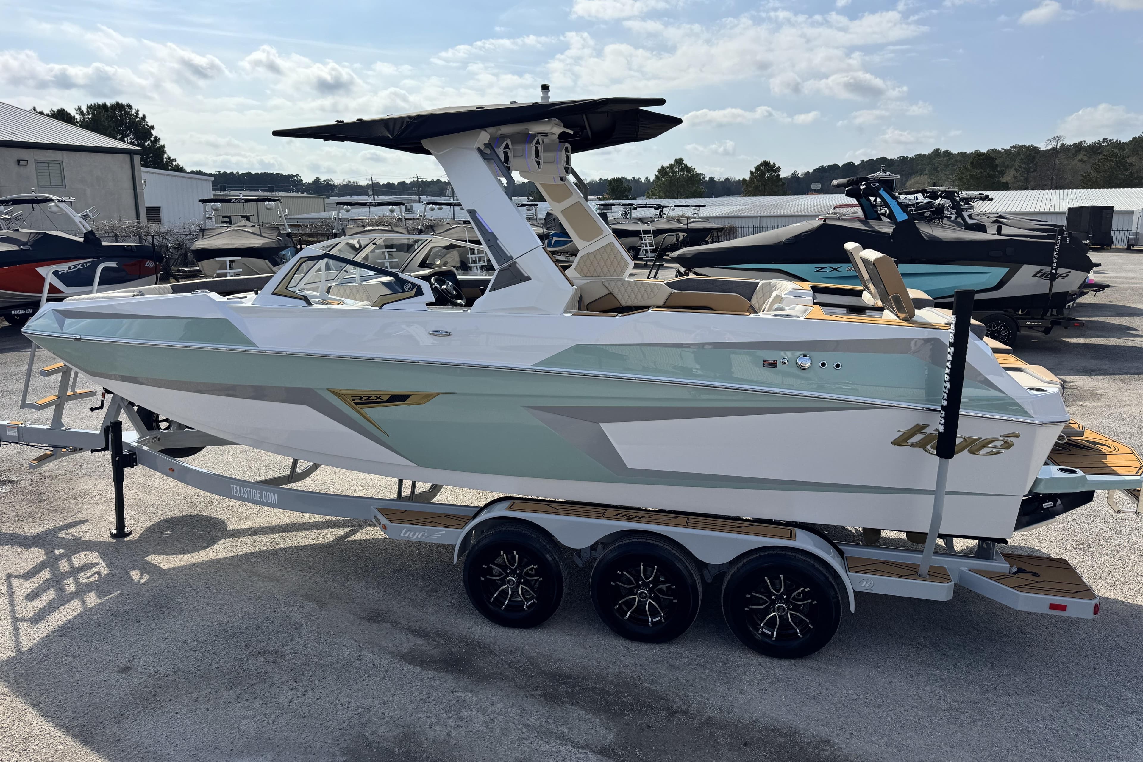 2026 Tigé 24RZX boat on trailer, sleek design, outdoor showroom setting.