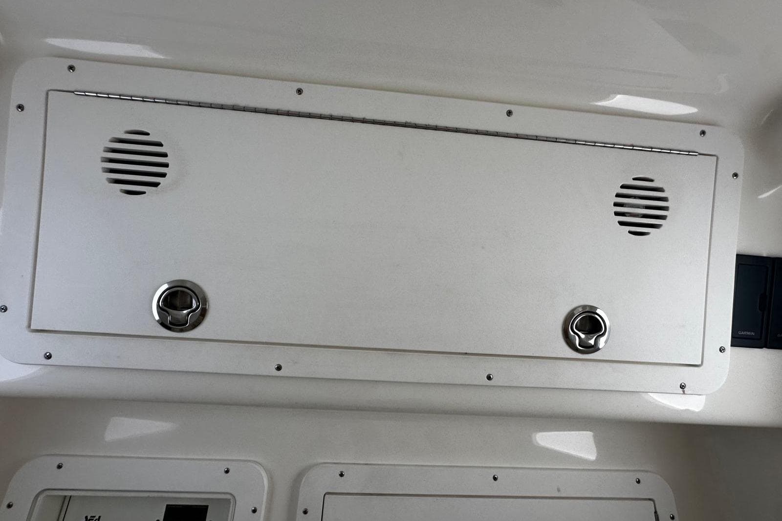 2022 SeaVee 390Z boat interior panel with speakers and latches.