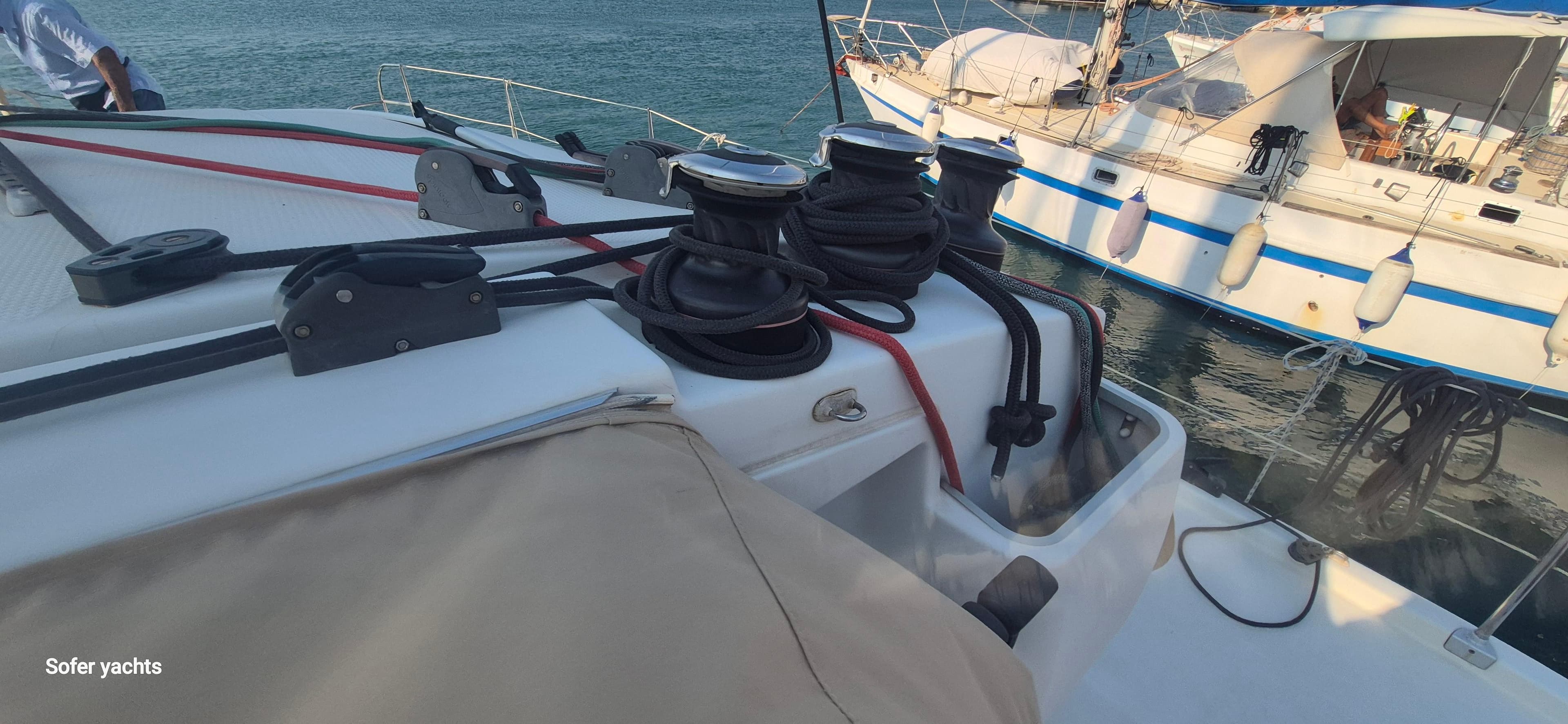 Fountaine Pajot Lipari 41 catamaran deck with ropes and winches, docked beside another boat.