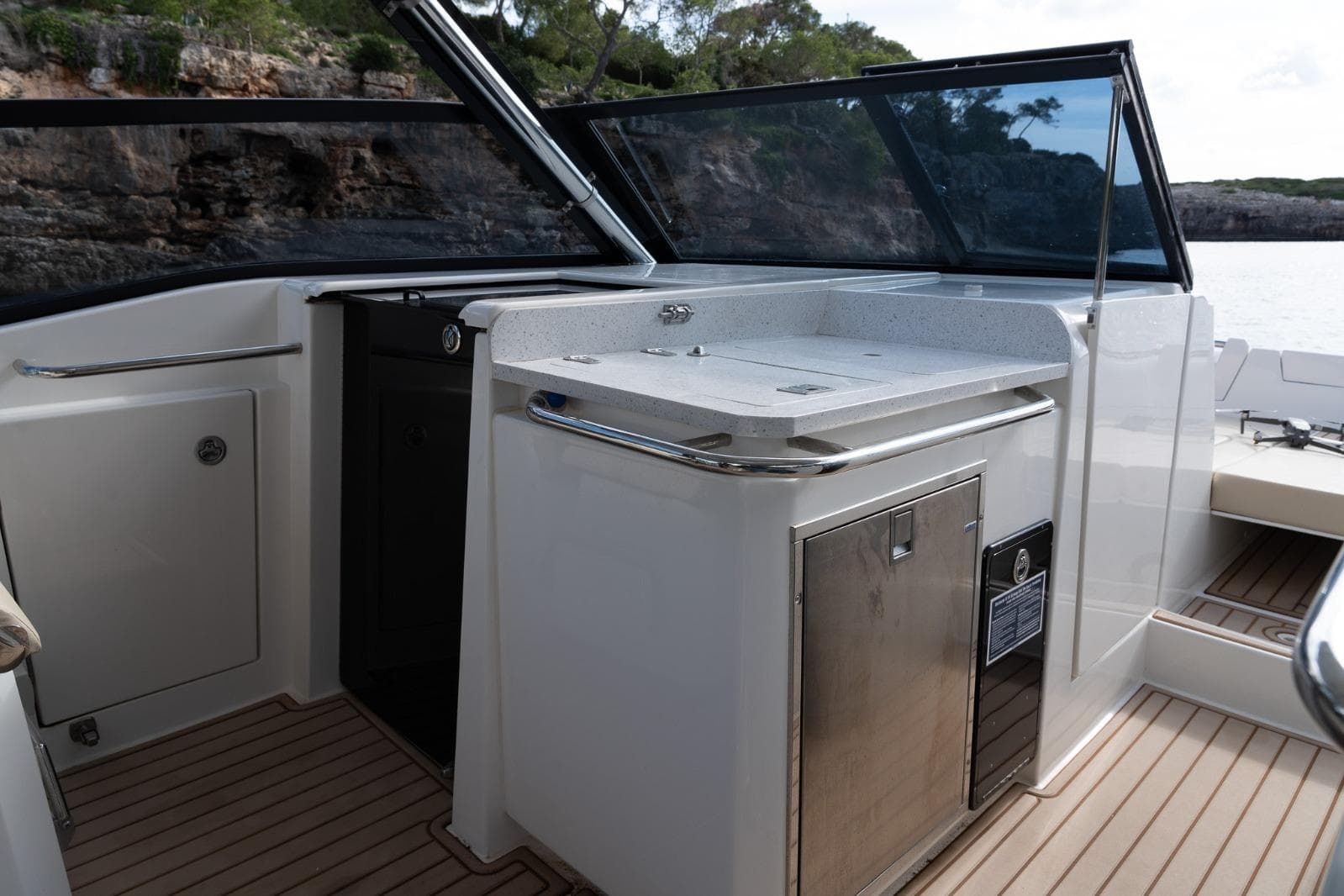 2023 Aquila 32 yacht interior with sleek kitchenette and modern design.