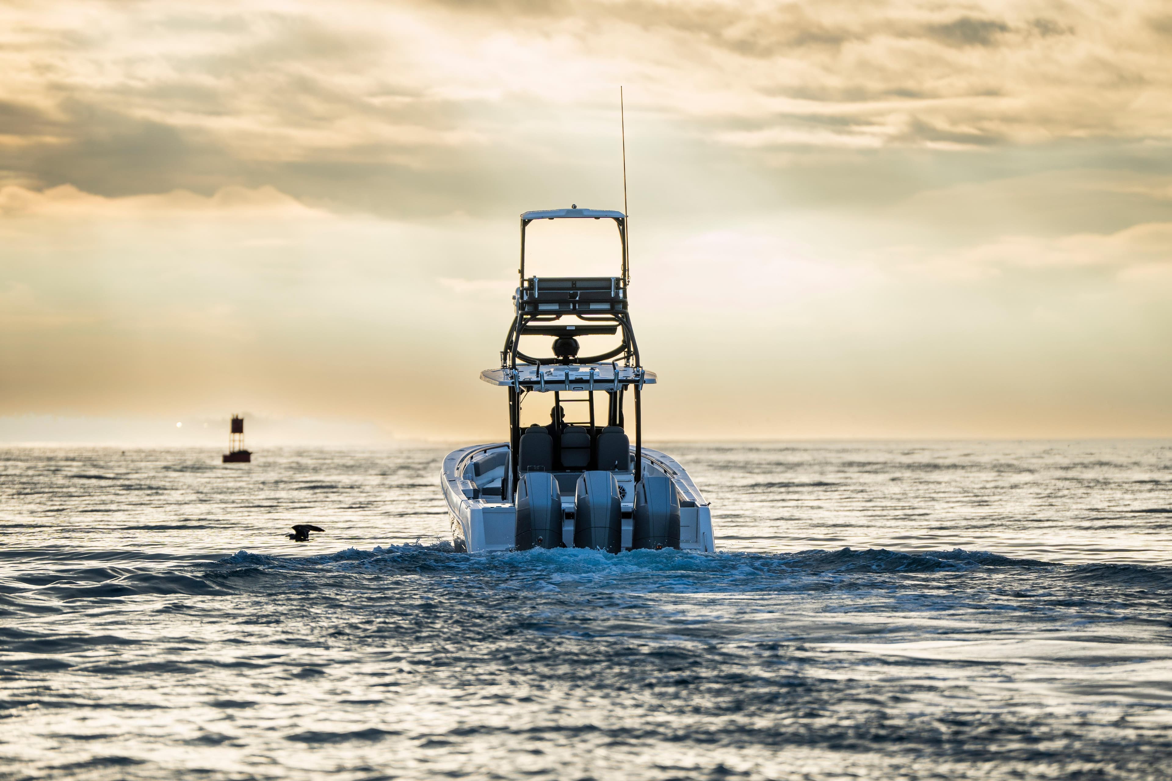 2024 Everglades 365 Center Console boat cruising at sunset on open water.