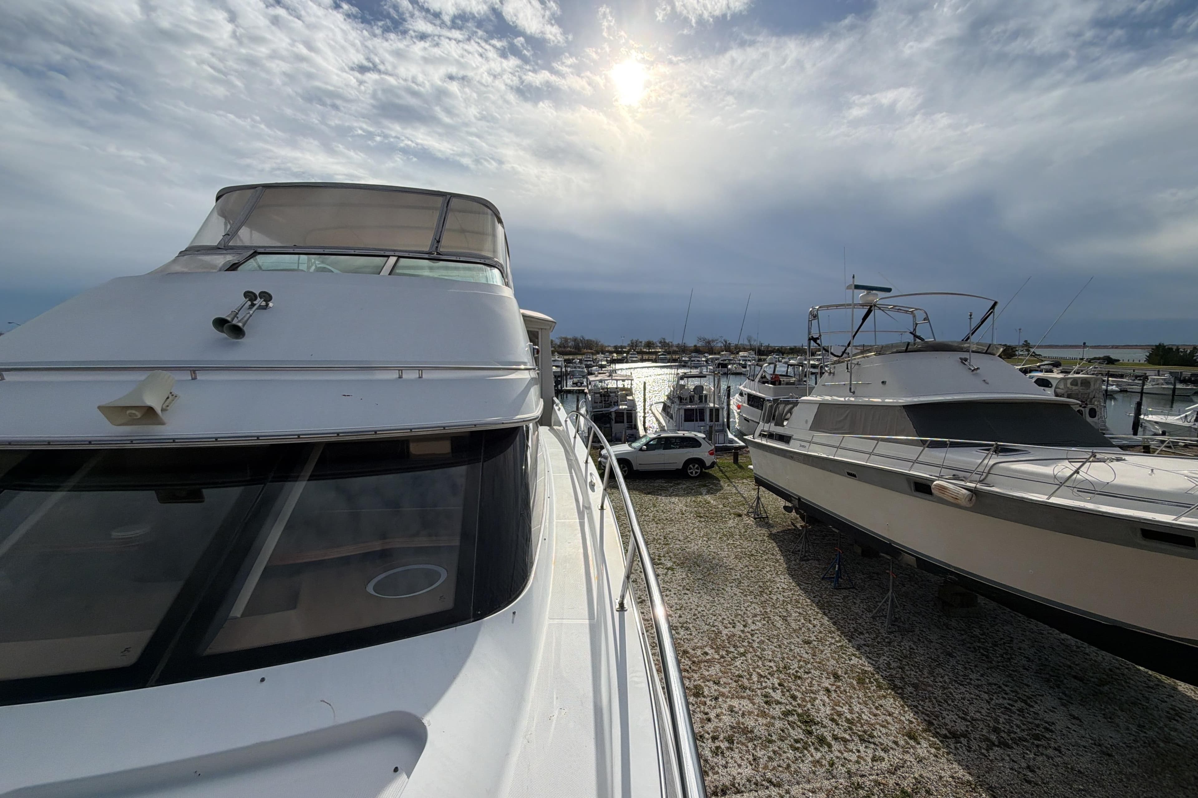 2003 Carver 564 Cockpit Motor Yacht docked at marina under cloudy sky.