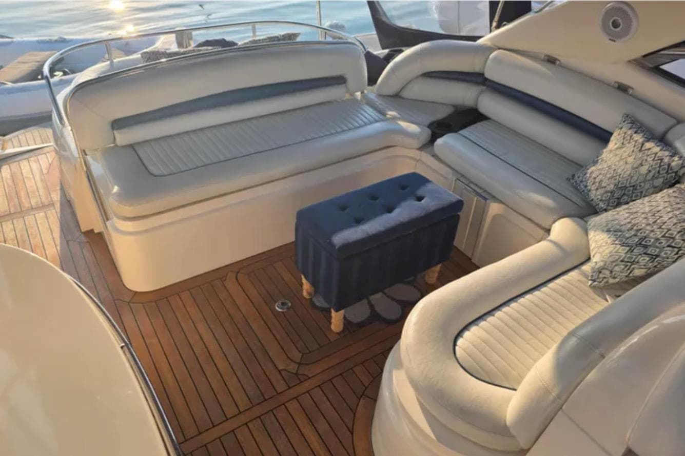 Luxurious seating area on a 2001 Sunseeker Camargue 44 yacht with elegant wood flooring.