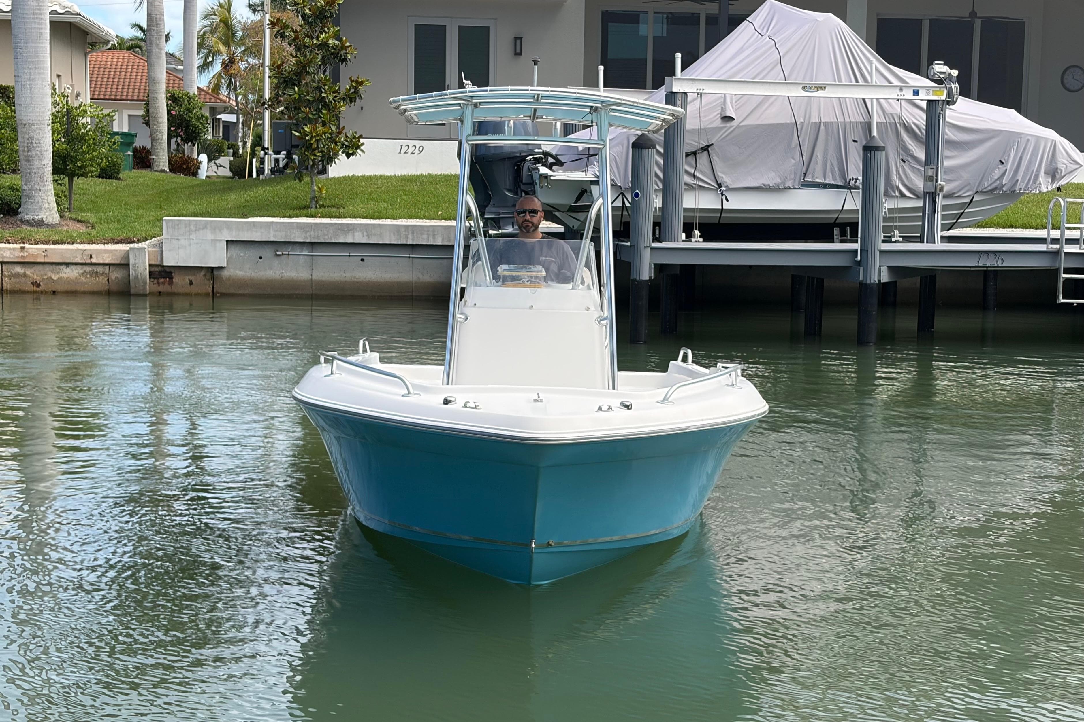2017 Release 196 RX boat on calm water near docked boats and waterfront homes.