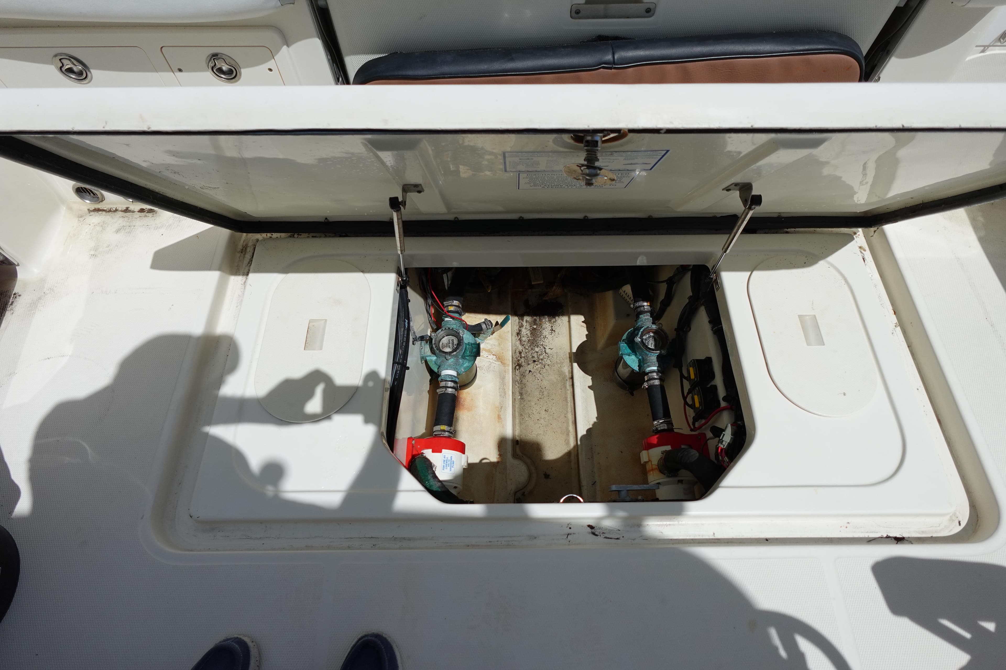 Open hatch of a 2005 Hydra-Sports Vector 3300 CC boat, revealing internal components.
