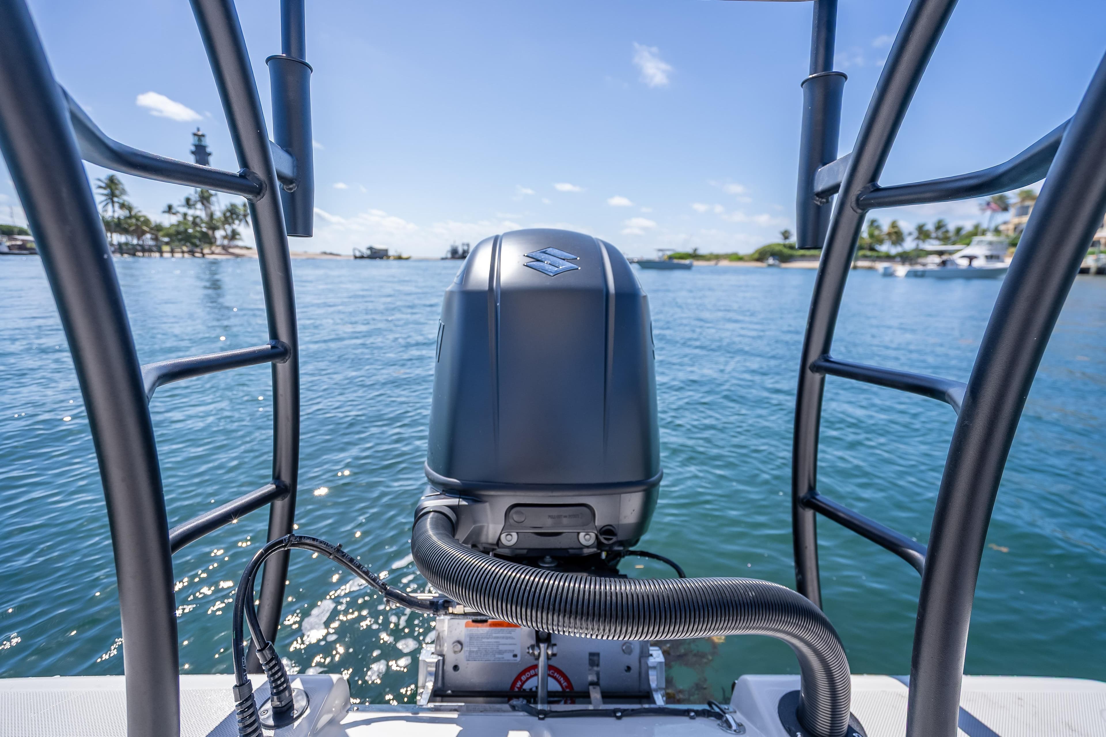 2026 Spyder FX19 Vapor boat engine on calm blue water, tropical background.
