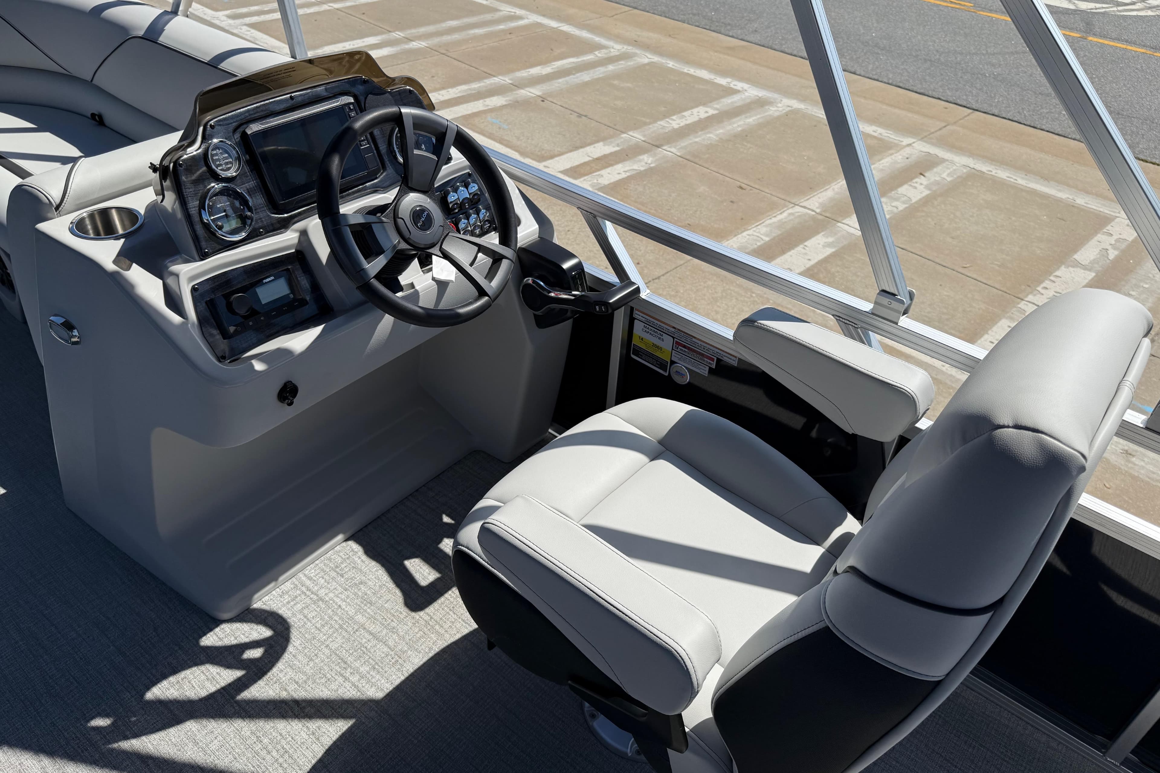 2026 Avalon Venture 85 Versatile rear Bench boat interior with steering console and captain's chair.