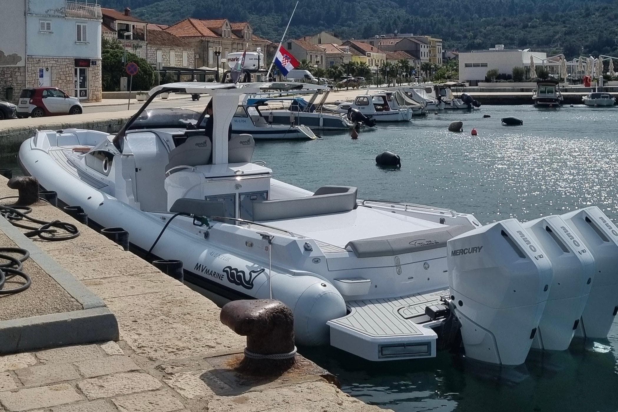 2024 MV Marine Mito 40 boat docked at a scenic marina with multiple engines.