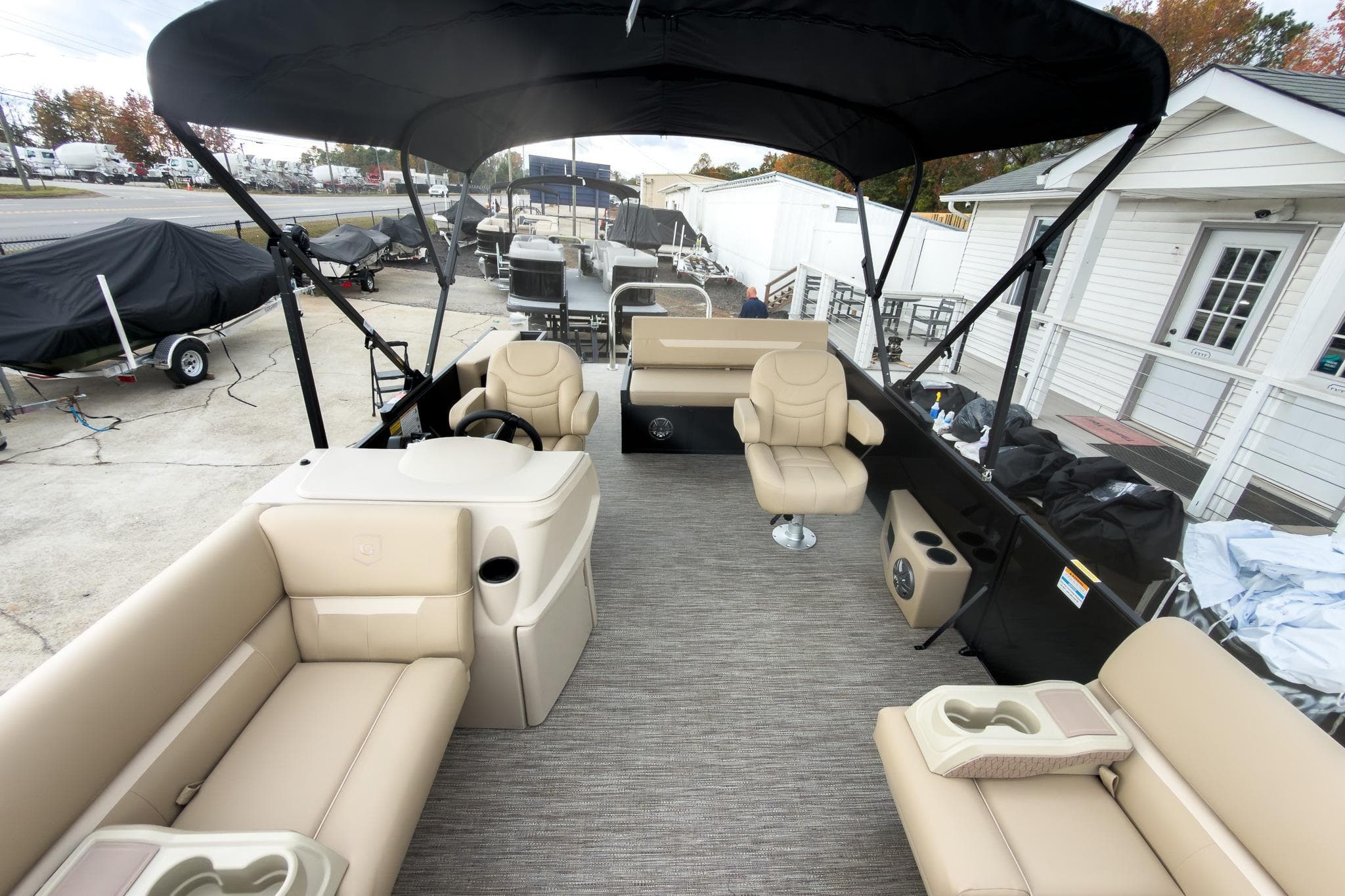 2026 Godfrey Sweetwater Xperience 22' Tritoon with beige seating and black canopy.