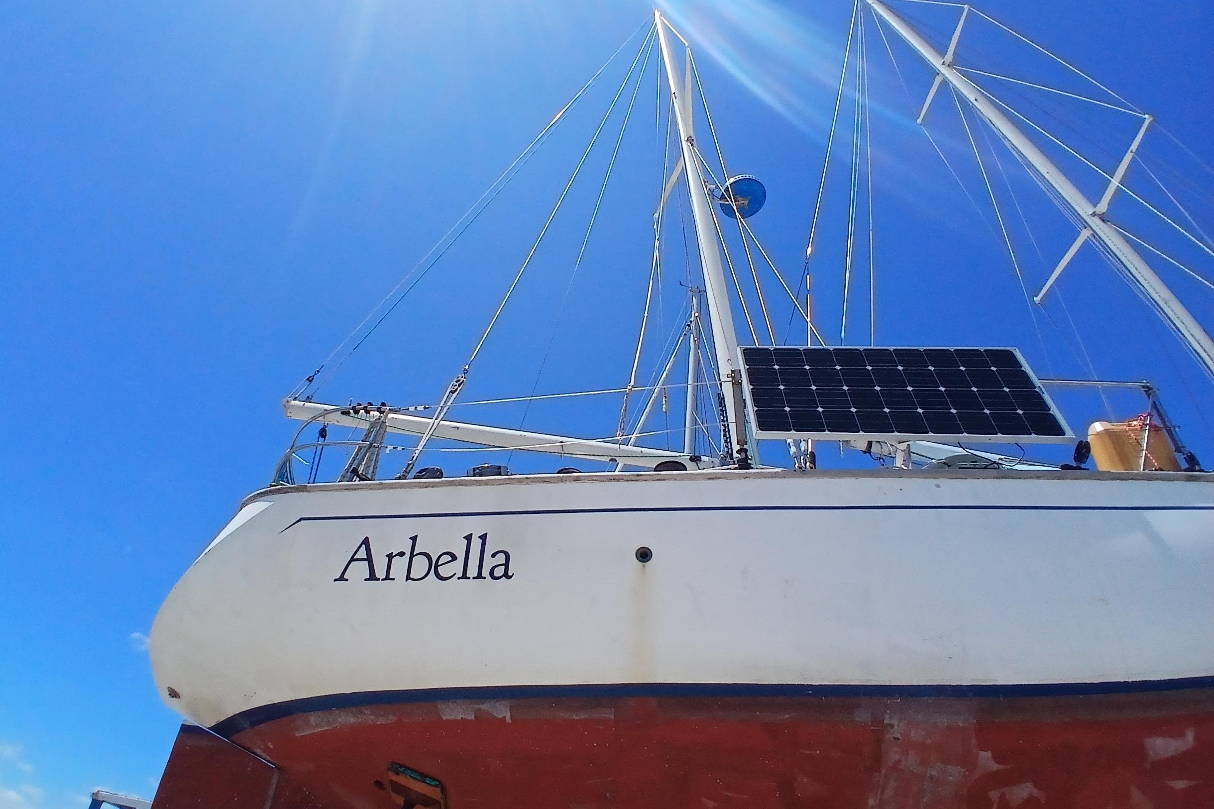 Sailboat "Arbella" with solar panel, Kaufman Skye 51, 1981, under clear blue sky.