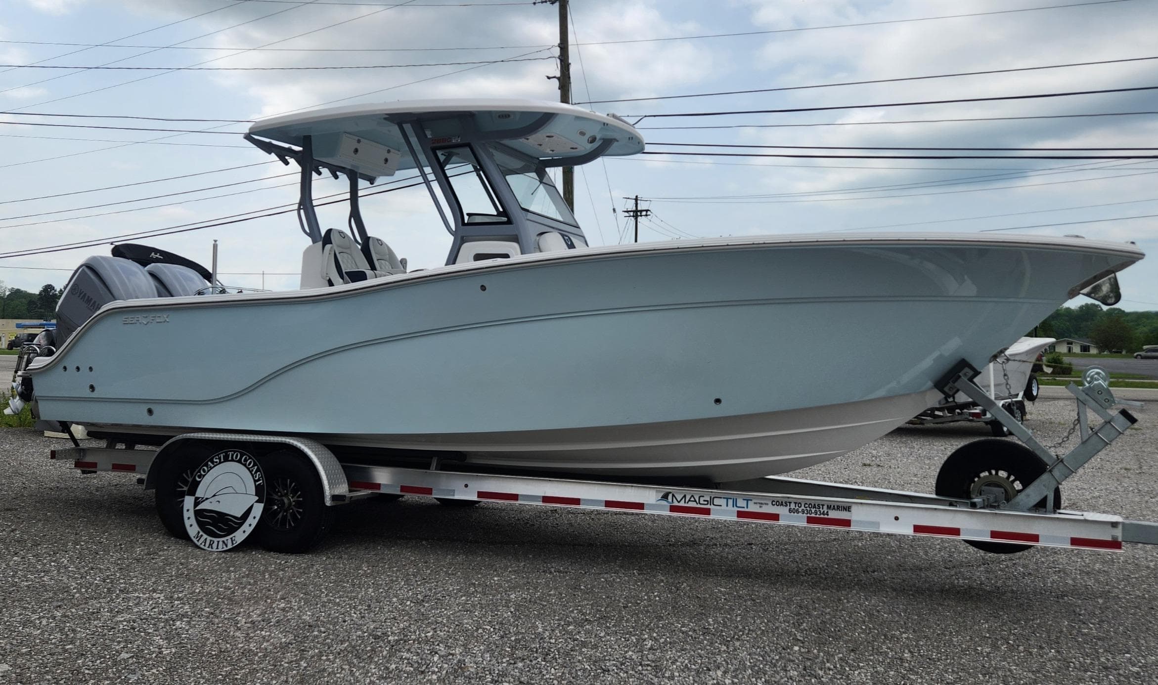 2025 Sea Fox 288 Commander boat on trailer, side view, outdoors.