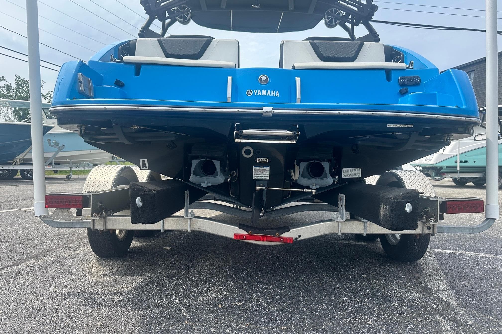 2023 Yamaha Boats 222XD in blue on a trailer, rear view.