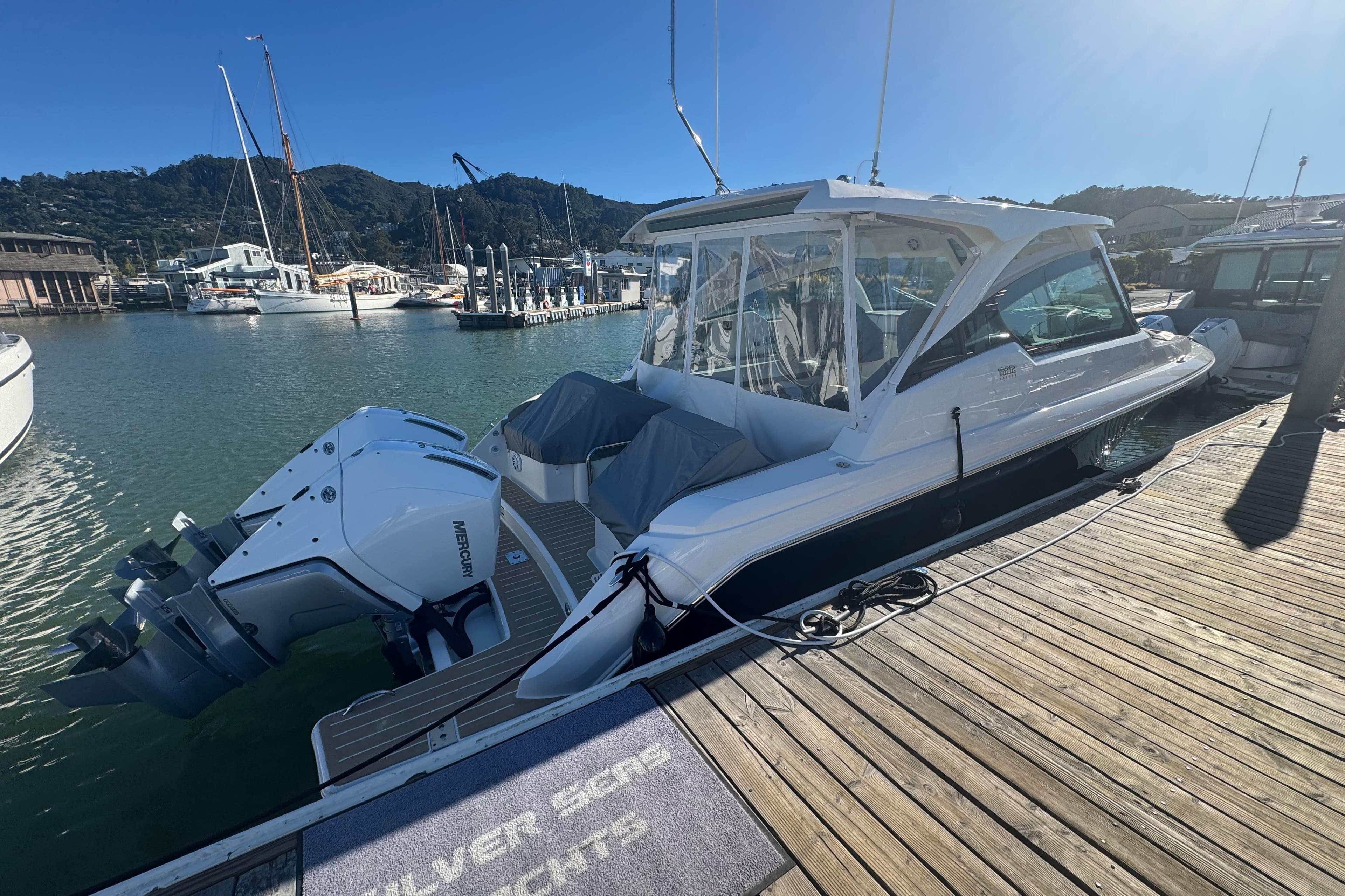 2026 Tiara Yachts 34 LX docked, featuring dual Mercury outboard engines.