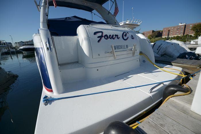 2007 Formula 34 PC boat docked, rear view with "Four C's" name visible.