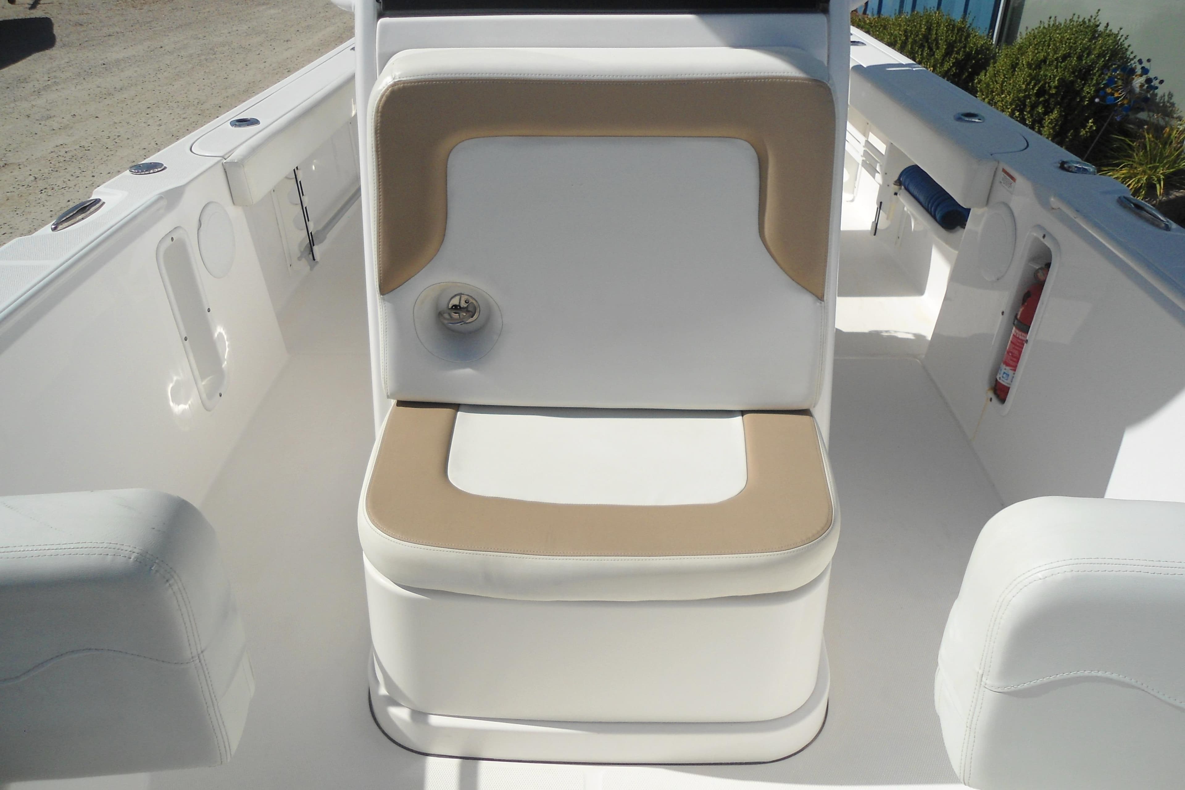2019 Edgewater 230CC boat interior with cushioned seating and white deck.