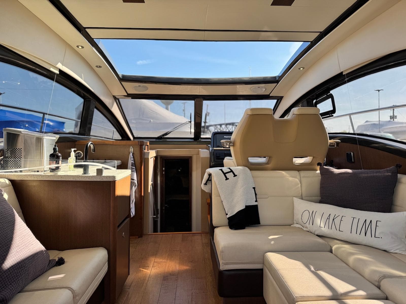 Interior of 2016 Sea Ray 400 Sundancer yacht with luxurious seating and panoramic windows.