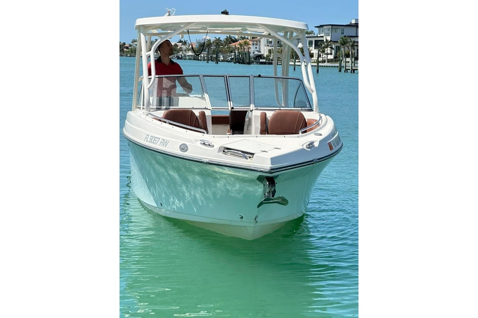 2019 Century 24 Resorter boat on clear turquoise water, sunny day.