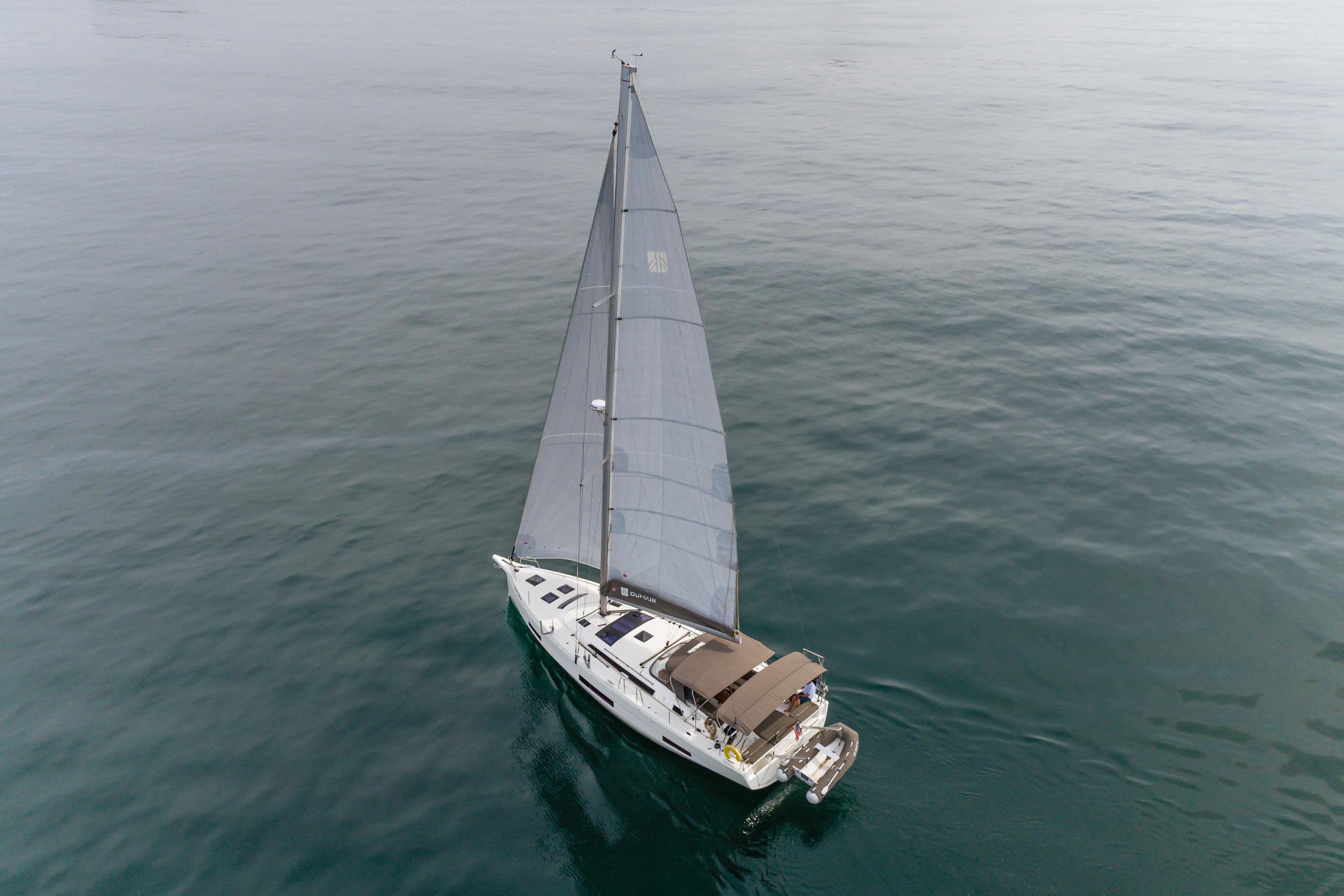 2024 Dufour 470 sailboat cruising on calm ocean waters.