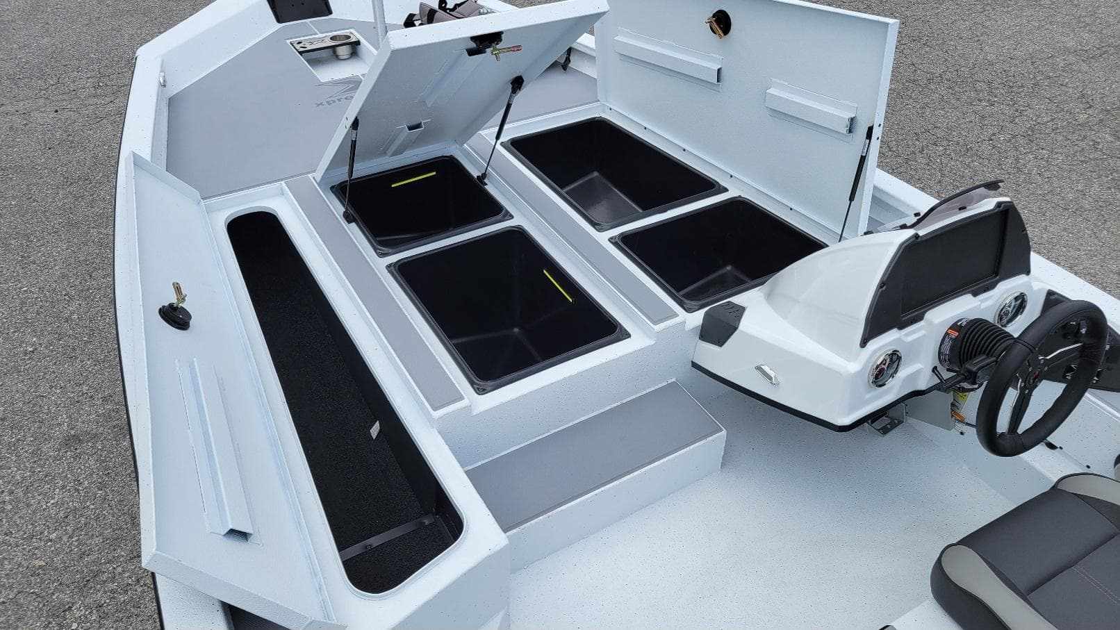 2026 Xpress H20 Bass boat interior with storage compartments and steering console.