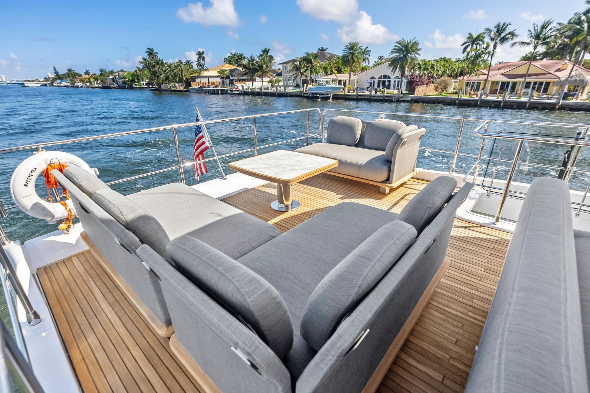 Luxurious 2020 Azimut 66 yacht deck with elegant seating, overlooking serene waterfront views.