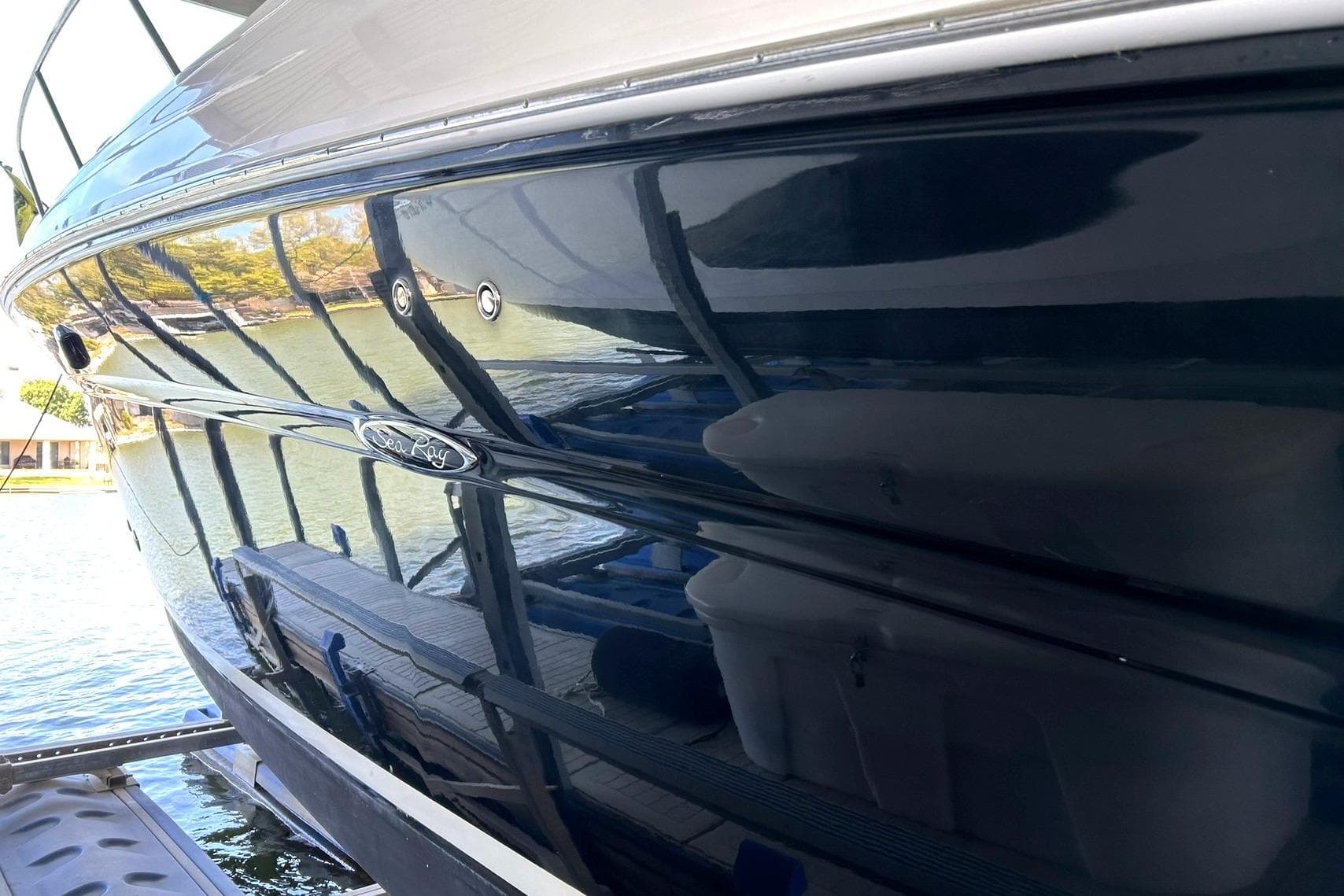 2006 Sea Ray Sundancer 320 boat reflecting water and surroundings.