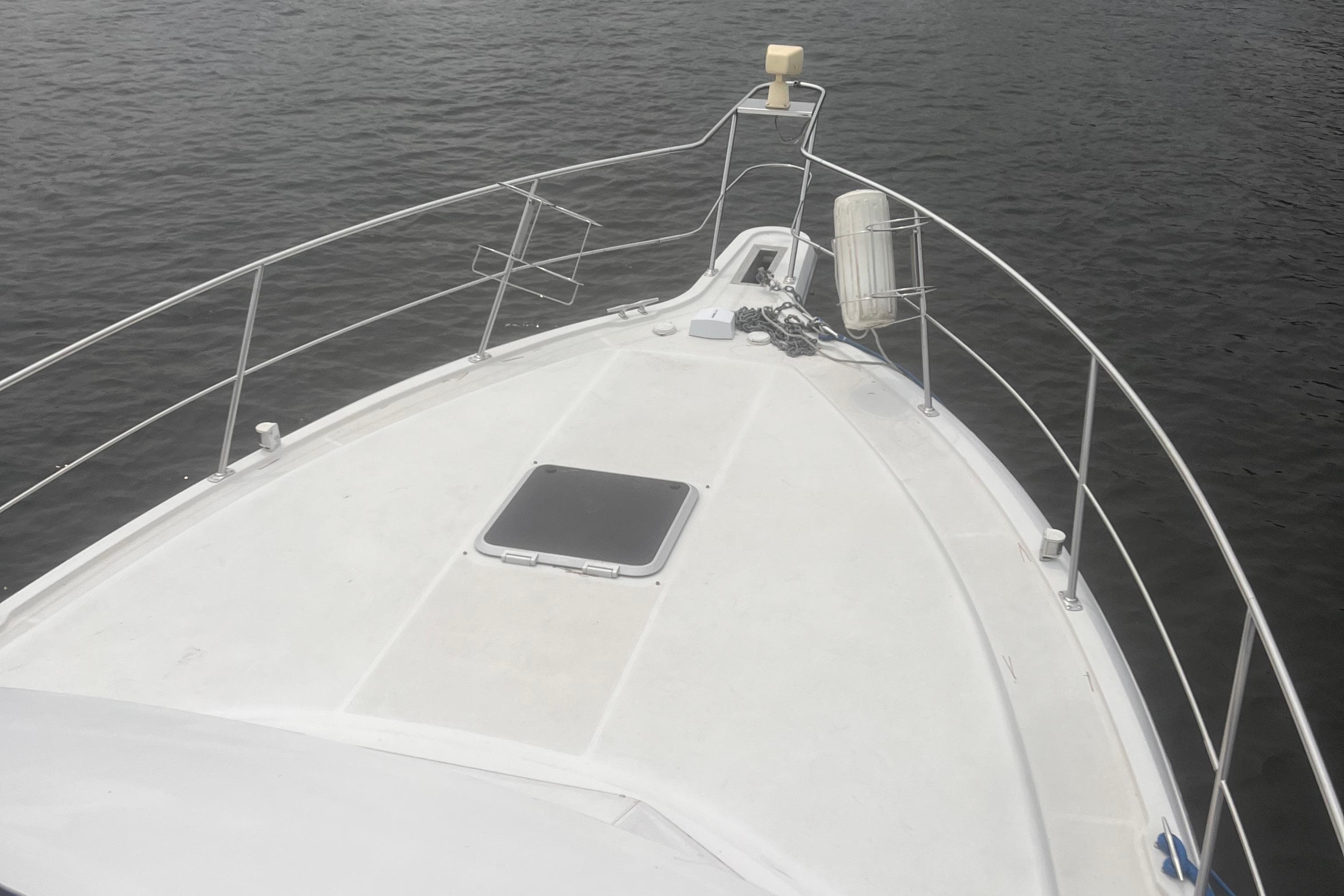 Bow view of 1994 Carver 350 yacht on calm water.