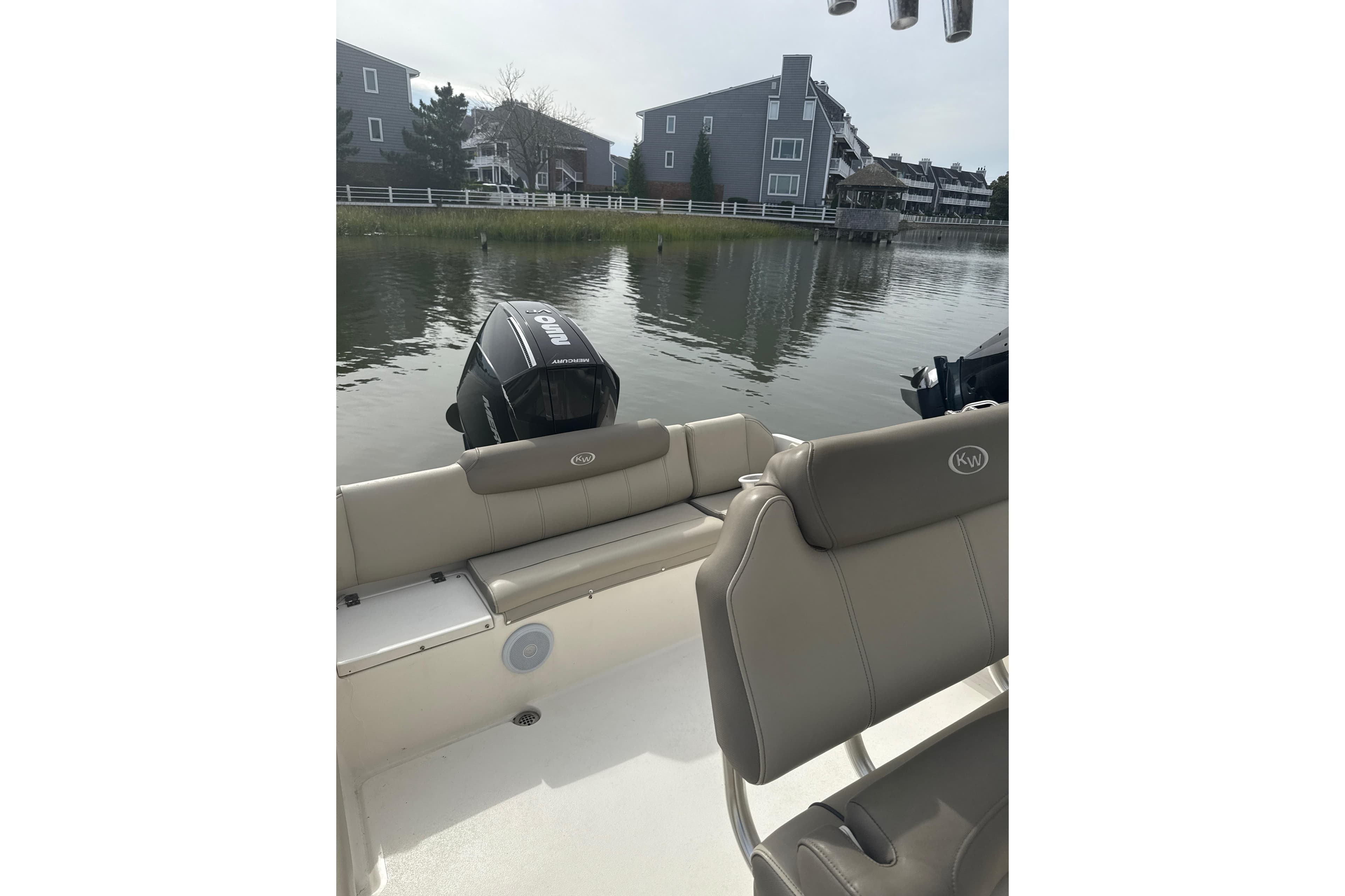 2024 Key West 239 FS boat interior with seating and outboard motor on calm water.