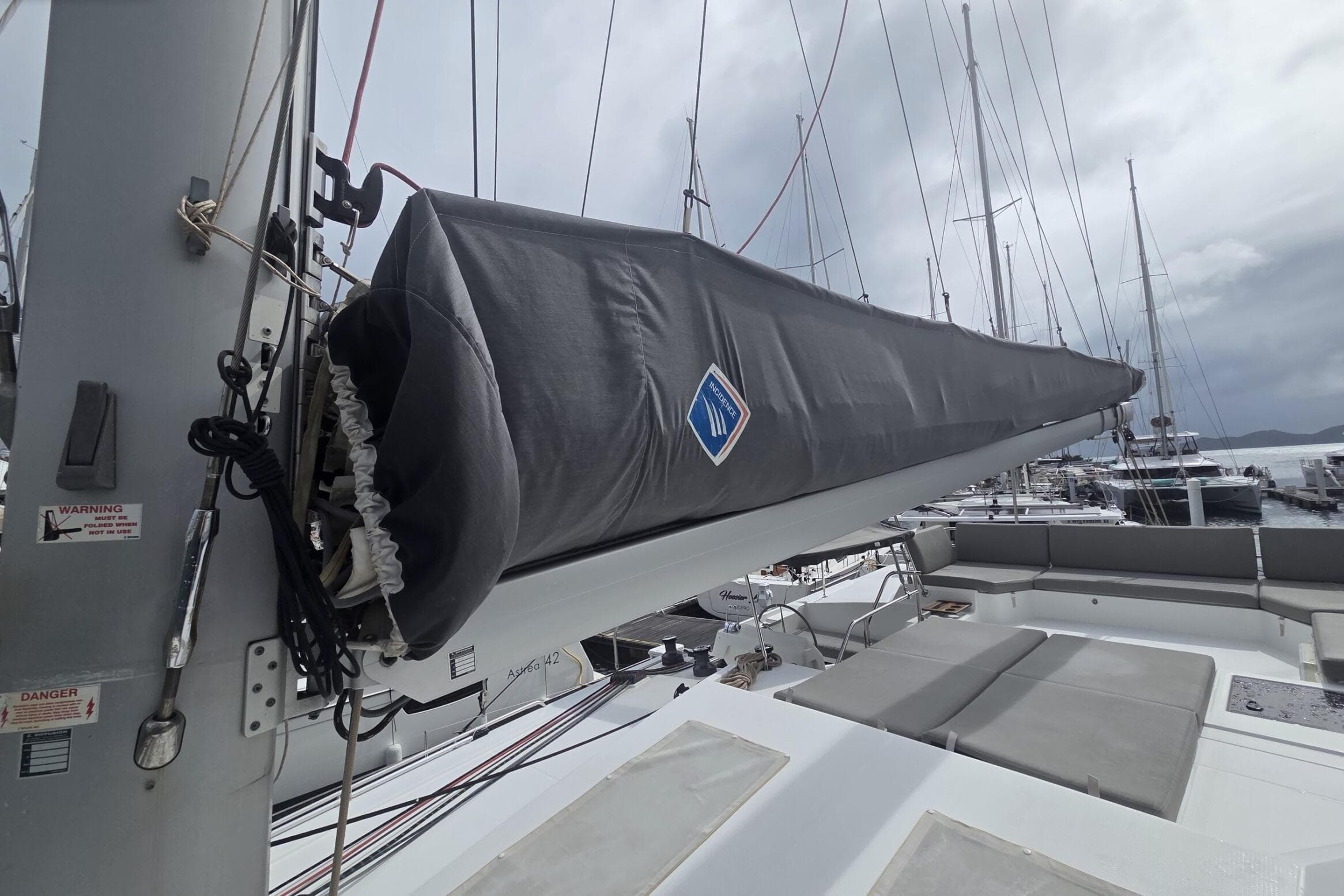 2022 Fountaine Pajot Elba 45 Catamaran with covered boom, docked in marina.