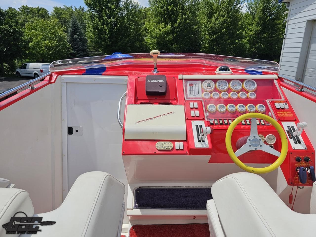 Interior of a 2004 Sonic USA 45SS boat with red dashboard and steering wheel.