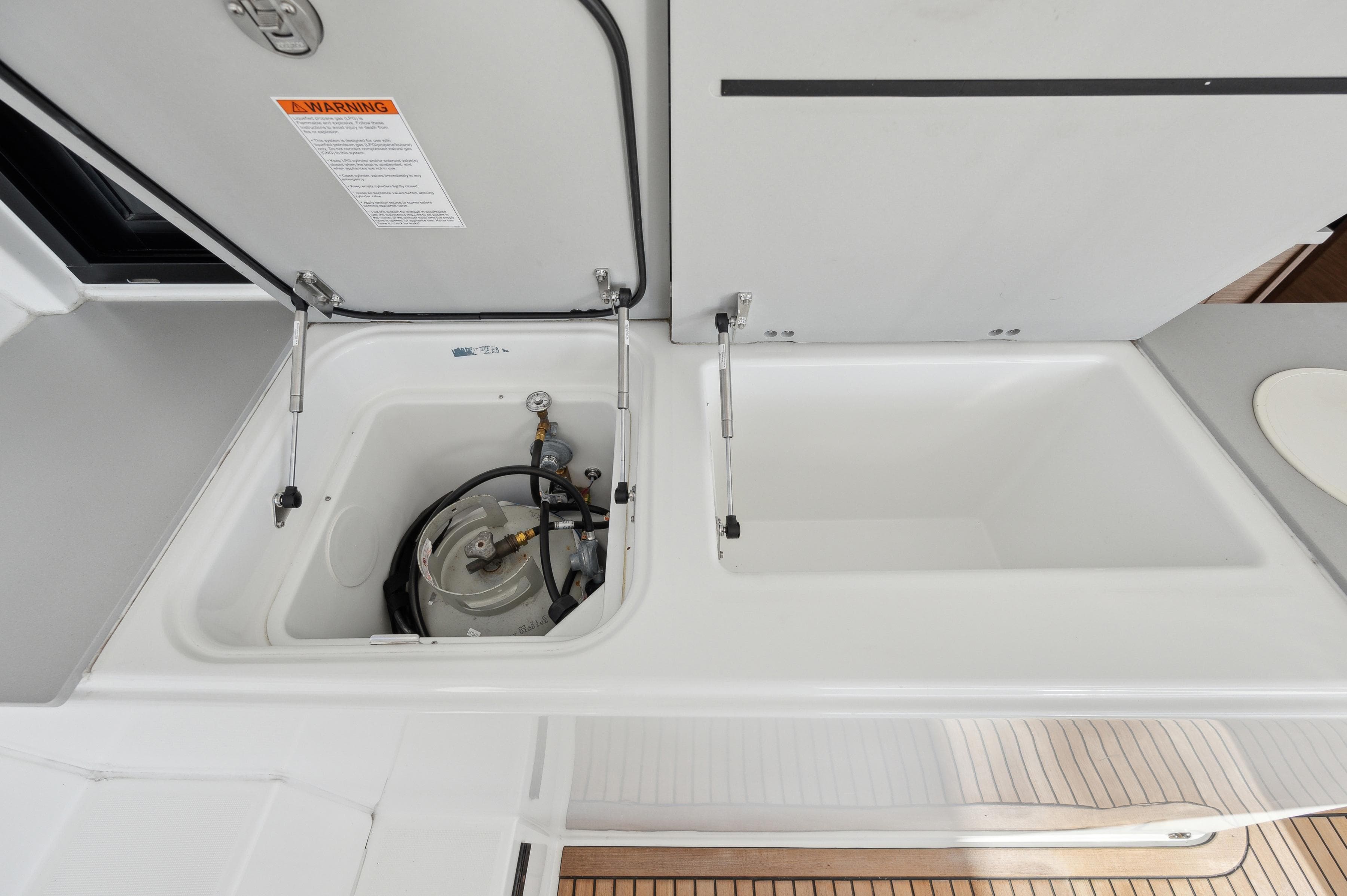 Lagoon 46 yacht 2022 model with open storage compartment and equipment.